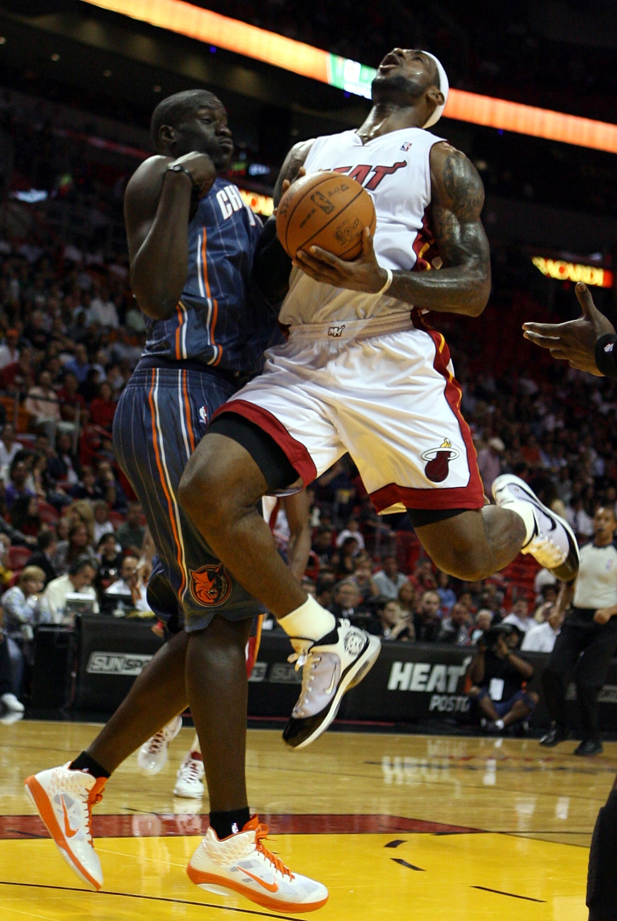 MIAMI - OCTOBER 18:  Forward LeBron James #6 of the Miami Heat is fouled by Boris Diaw #32 of the Charlotte Bobcats at American Airlines Arena on October 18, 2010 in Miami, Florida. NOTE TO USER: User expressly acknowledges and agrees that, by downloading