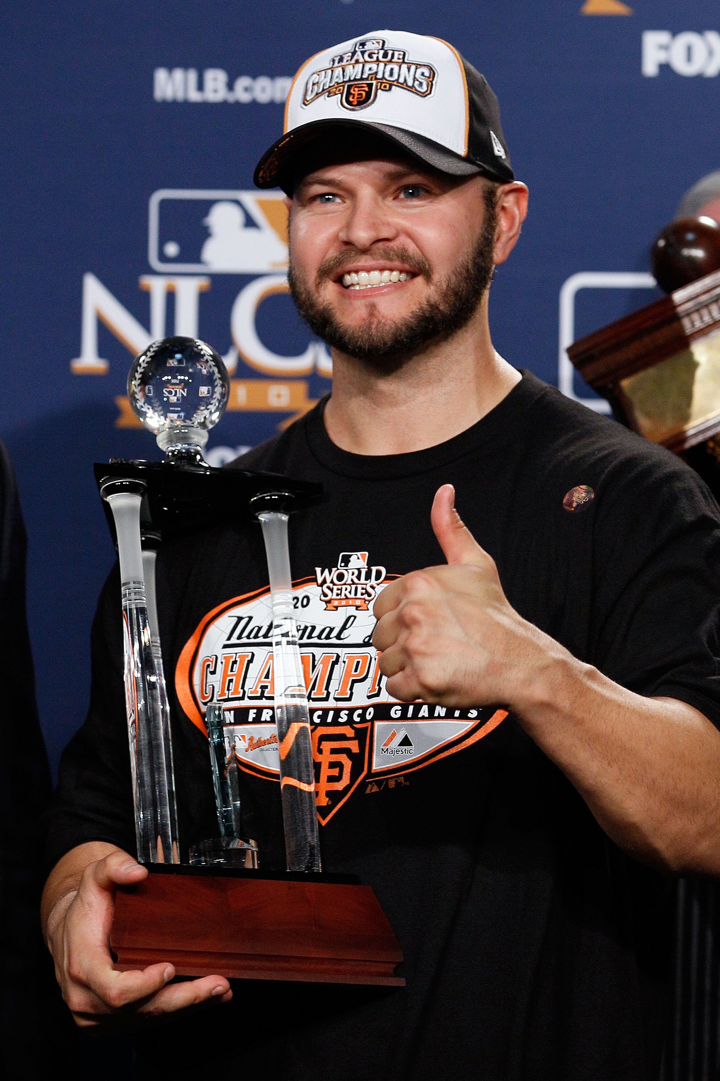 PHILADELPHIA - OCTOBER 23:  Cody Ross #13 of the San Francisco Giants celebrates with the NCLS MVP trophy after defeating the Philadelphia Phillies 3-2 and winning the pennant in Game Six of the NLCS during the 2010 MLB Playoffs at Citizens Bank Park on O