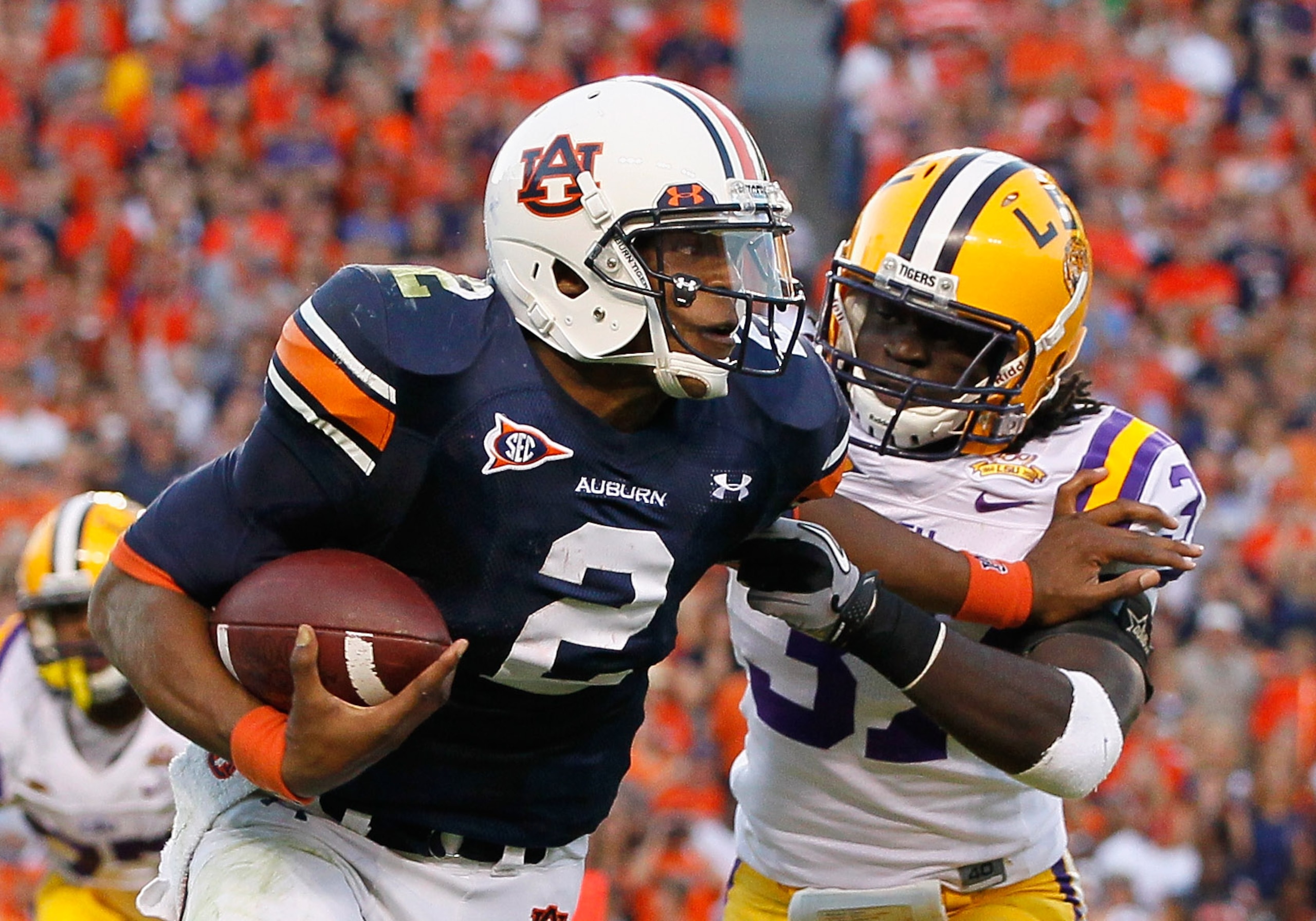AUBURN, AL - OCTOBER 23:  Quarterback Cameron Newton #2 of the Auburn Tigers stiff arms Karnell Hatcher #37 of the LSU Tigers at Jordan-Hare Stadium on October 23, 2010 in Auburn, Alabama.  (Photo by Kevin C. Cox/Getty Images)