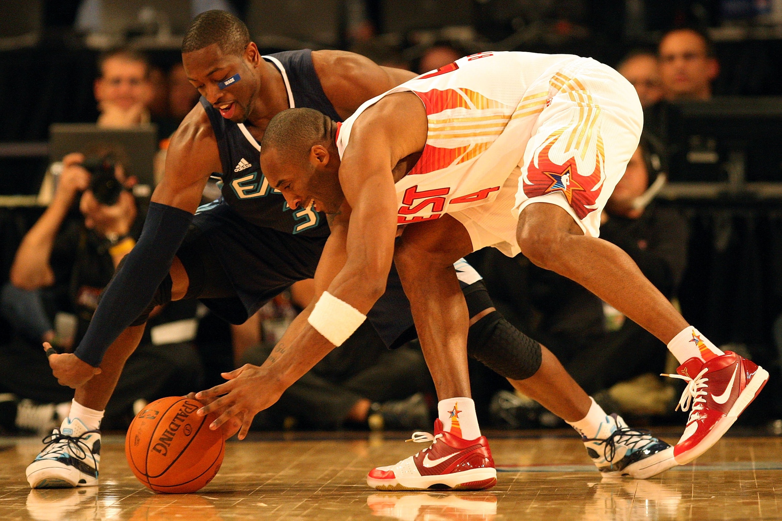 PHOENIX - FEBRUARY 15:  Dwyane Wade #3 of the Eastern Conference and Kobe Bryant #24 of the Western Conference go after a loose ball during the 58th NBA All-Star Game, part of 2009 NBA All-Star Weekend at US Airways Center on February 15, 2009 in Phoenix,