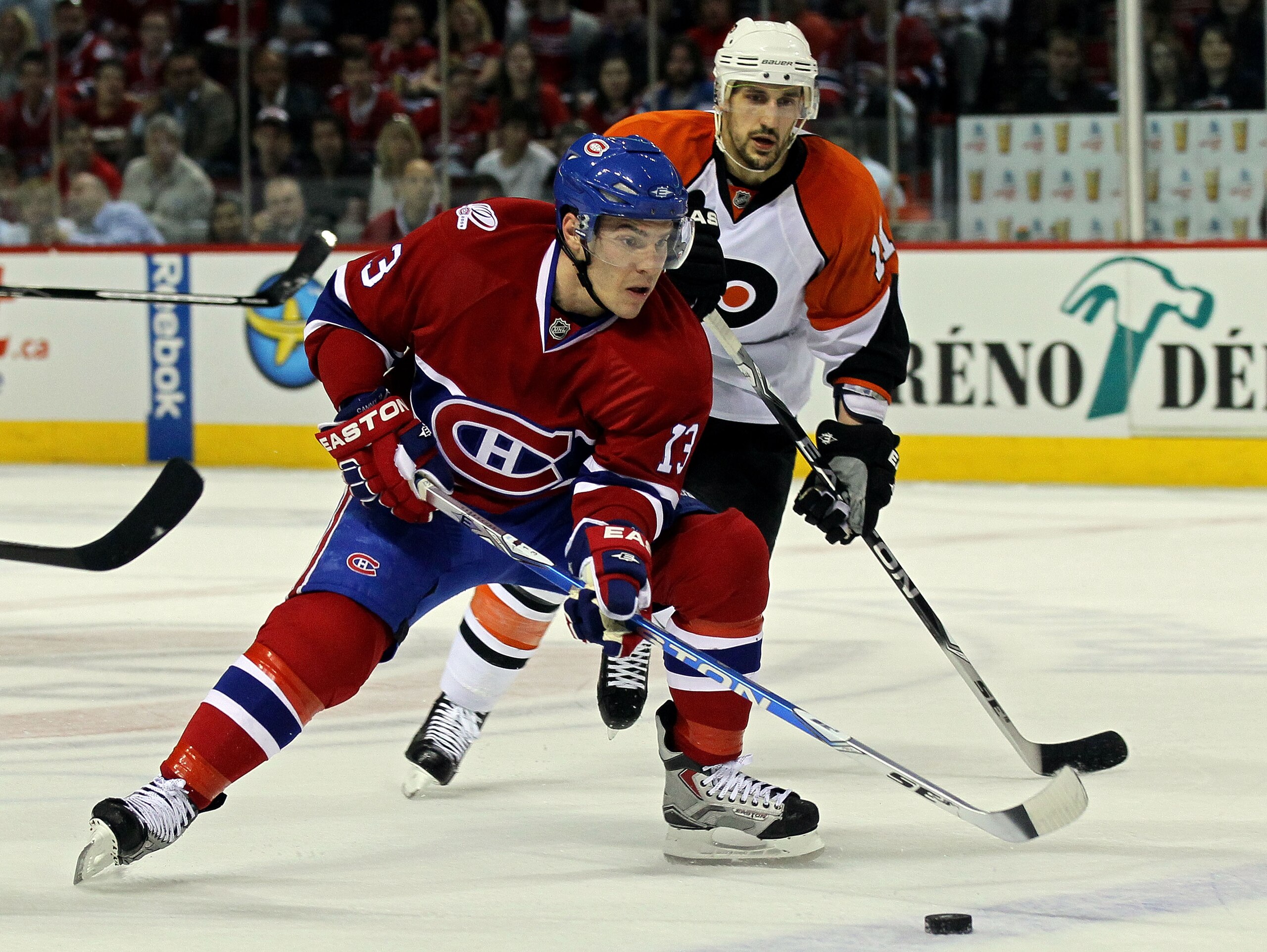 MONTREAL, QC - MAY 22:  Mike Cammalleri #13 of the Montreal Canadiens handles the puck against  Blair Betts #11 of the Philadelphia Flyers in Game 4 of the Eastern Conference Finals during the 2010 NHL Stanley Cup Playoffs at Bell Centre on May 22, 2010 i