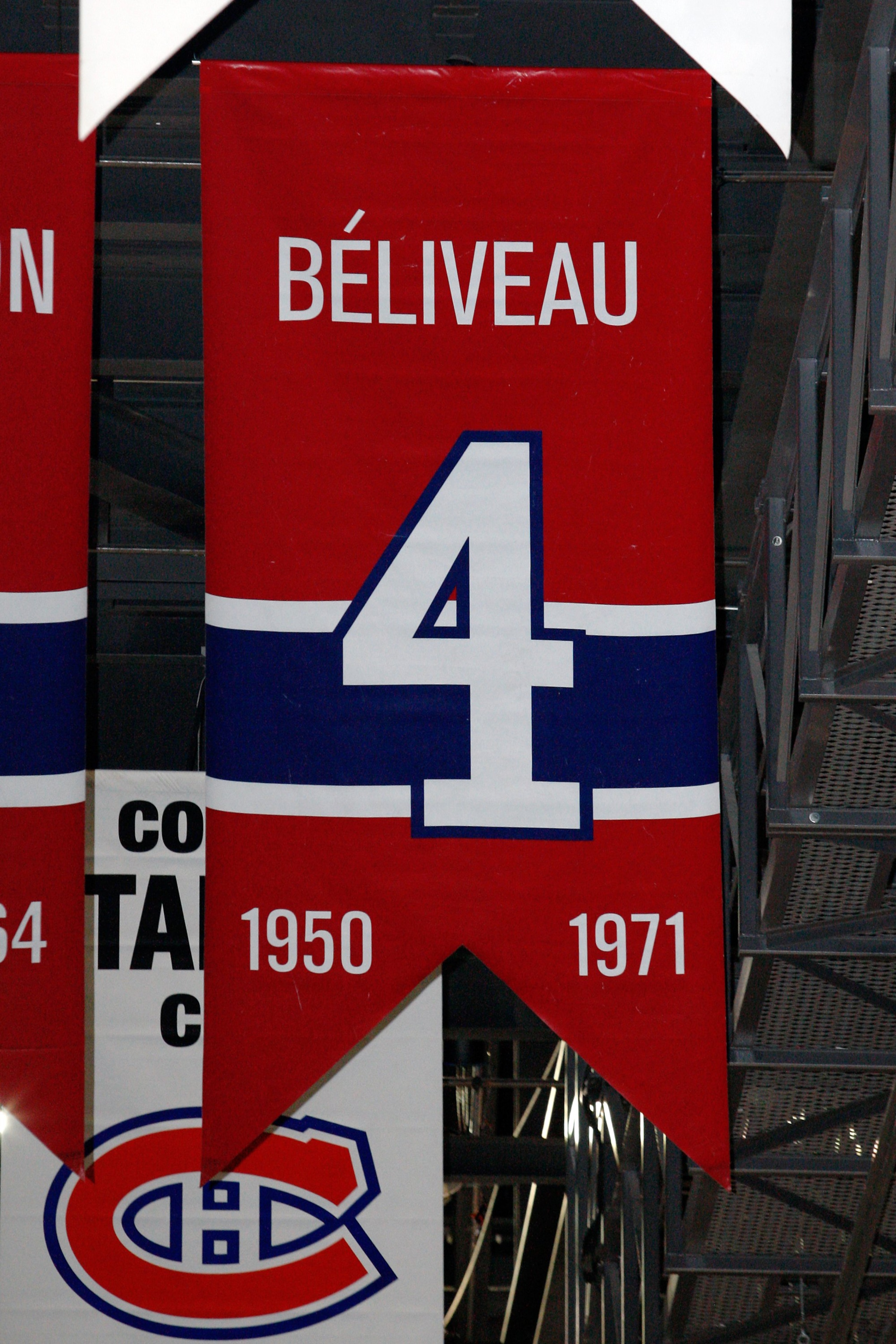 MONTREAL- APRIL 19: A photo of the banner commemorating the retired jersey of Jean Beliveau hanging in the Bell Centre prior to Game Three of the Eastern Conference Quarterfinals between the Washington Capitals and Montreal Canadiens during the 2010 NHL MONTREAL- APRIL 19: A photo of the banner commemorating the retired jersey of Jean Beliveau hanging in the Bell Centre prior to Game Three of the Eastern Conference Quarterfinals between the Washington Capitals and Montreal Canadiens during the 2010 NHL