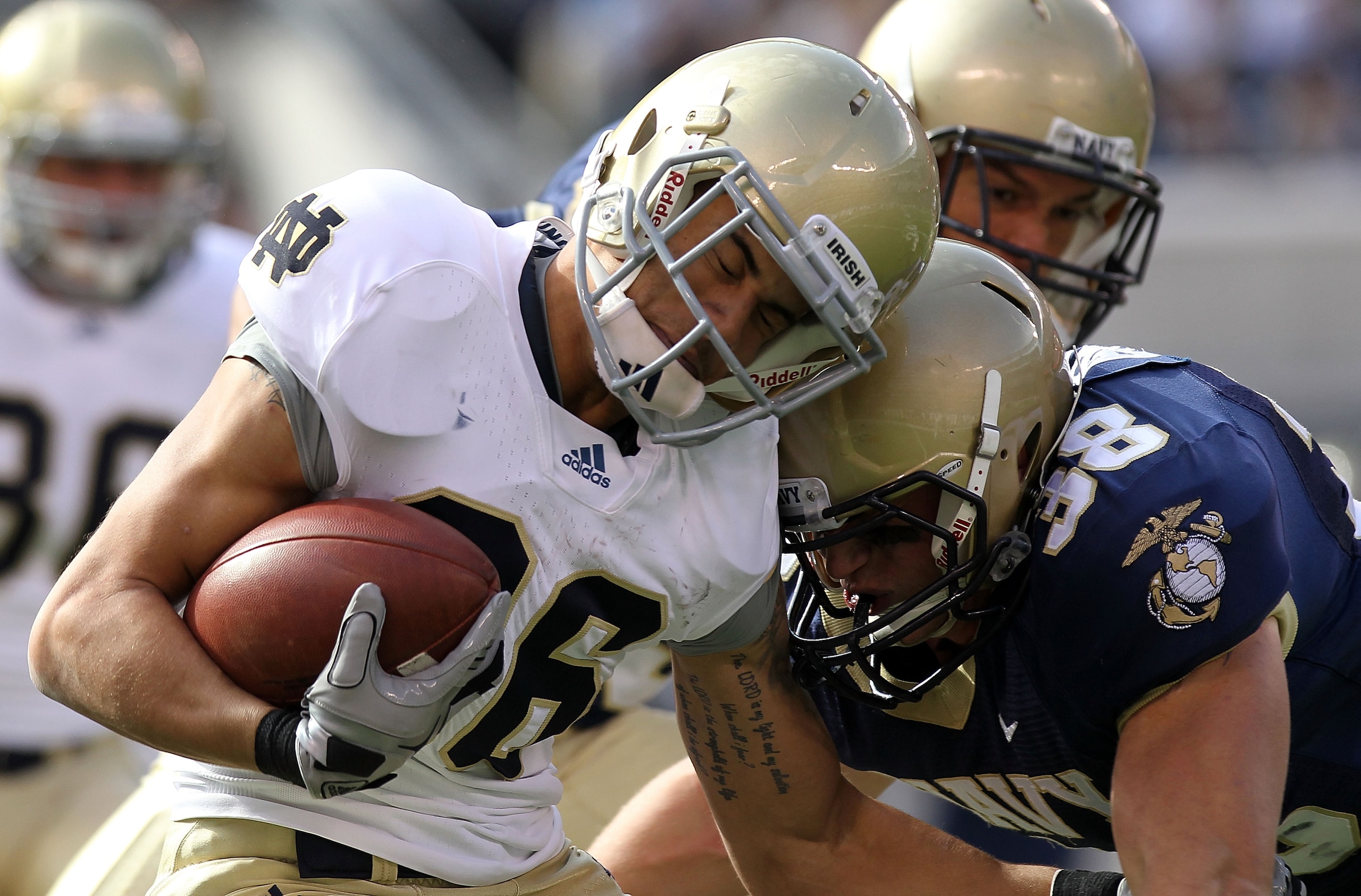 EAST RUTHERFORD, NJ - OCTOBER 23: Bennett Jackson #86 of the Notre Dame Fighting Irish is tackled by Matt Brewer #38 of the Navy Midshipmen at New Meadowlands Stadium on October 23, 2010 in East Rutherford, New Jersey. (Photo by Nick Laham/Getty Images) EAST RUTHERFORD, NJ - OCTOBER 23: Bennett Jackson #86 of the Notre Dame Fighting Irish is tackled by Matt Brewer #38 of the Navy Midshipmen at New Meadowlands Stadium on October 23, 2010 in East Rutherford, New Jersey. (Photo by Nick Laham/Getty Images)