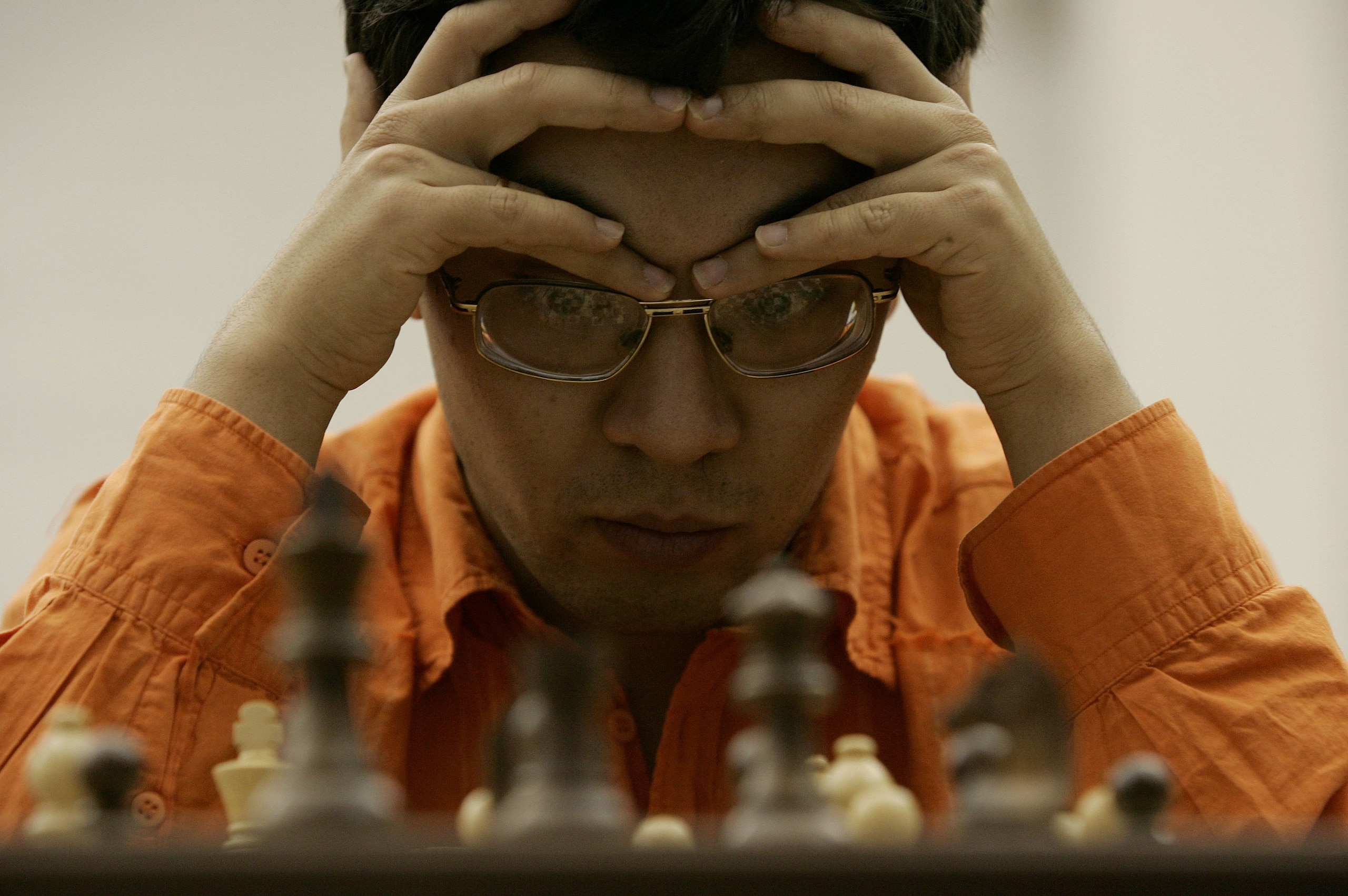 DOHA, QATAR - DECEMBER 02: Bu Xiangzhi of China contemplates his next move in the Men's Rapid Chess Individual during the 15th Asian Games Doha 2006 at the Khalifa Tennis & Squash Complex on December 2, 2006 in Doha, Qatar. (Photo by Streeter Lecka/Gett DOHA, QATAR - DECEMBER 02: Bu Xiangzhi of China contemplates his next move in the Men's Rapid Chess Individual during the 15th Asian Games Doha 2006 at the Khalifa Tennis & Squash Complex on December 2, 2006 in Doha, Qatar. (Photo by Streeter Lecka/Gett