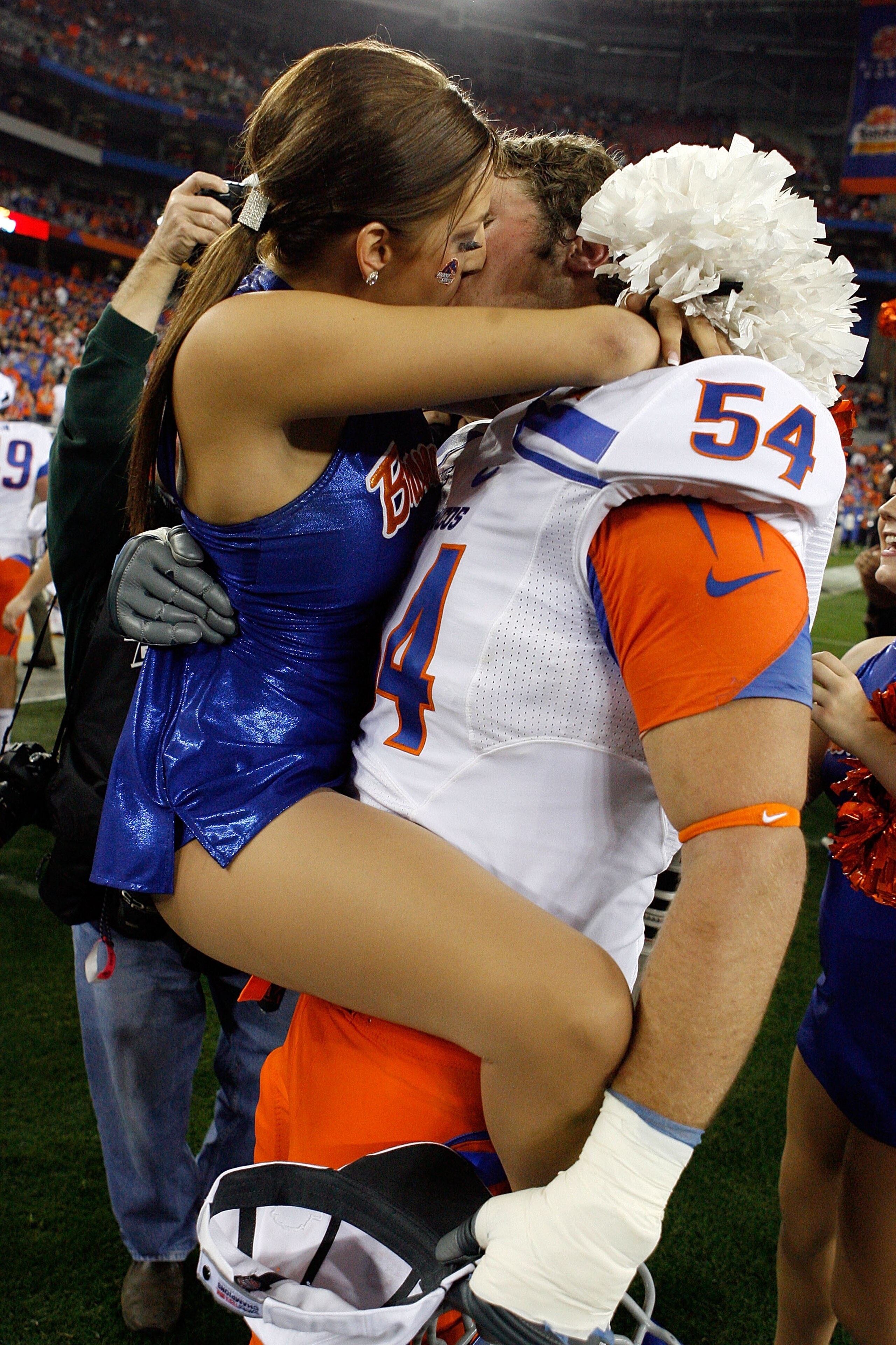 GLENDALE, AZ - JANUARY 04:  Michael Ames #54 of the Boise State Broncos kisses a cheerleader after the Broncos 17-10 victory against the TCU Horned Frogs during the Tostitos Fiesta Bowl at the Universtity of Phoenix Stadium on January 4, 2010 in Glendale,
