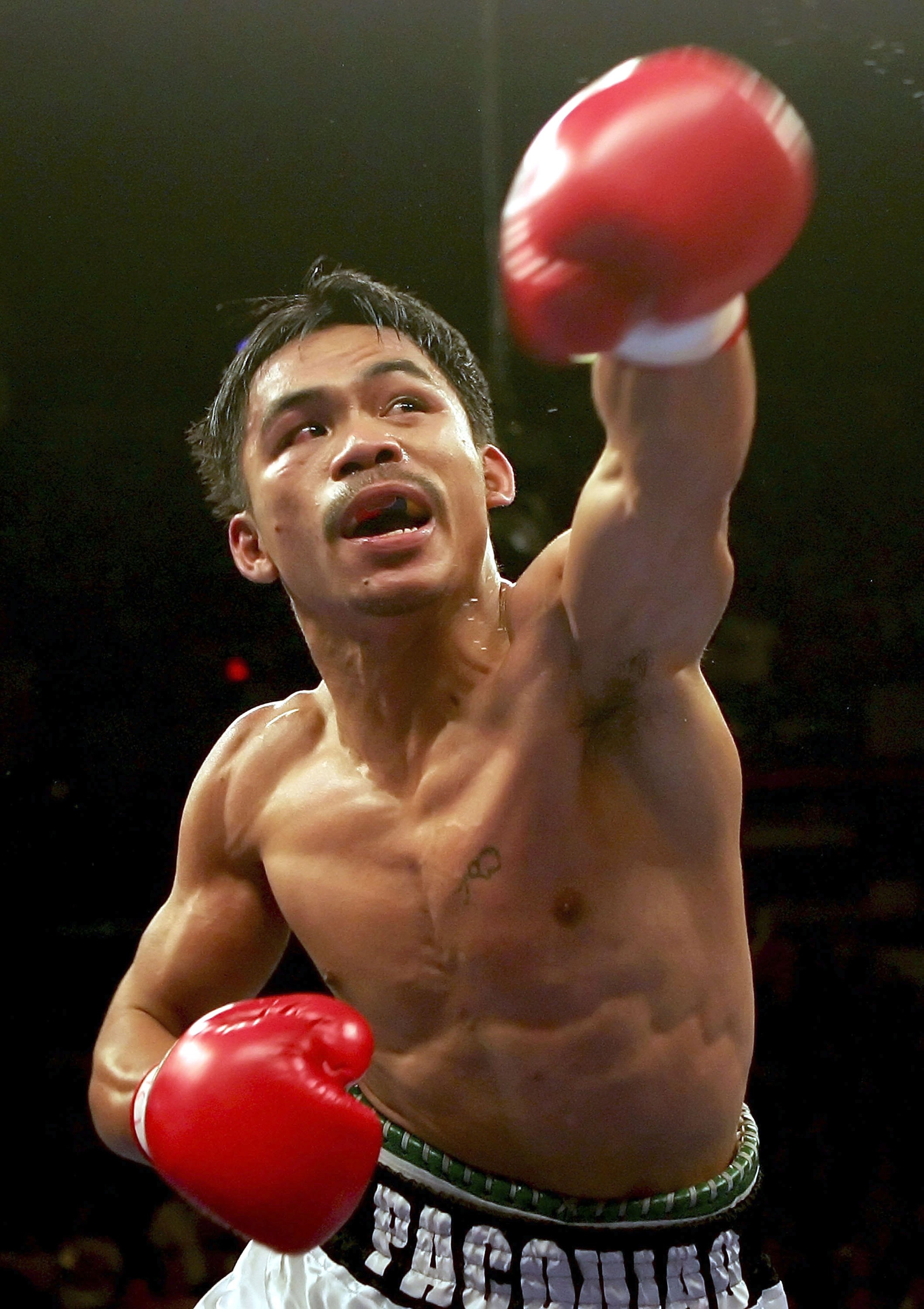 LAS VEGAS - NOVEMBER 18:  Manny Pacquiao of the Philippines throws a punch against Erik Morales during their super featherweight bout at the Thomas & Mack Center on November 18, 2006 in Las Vegas, Nevada. Pacquiao knocked out Morales in the third round.