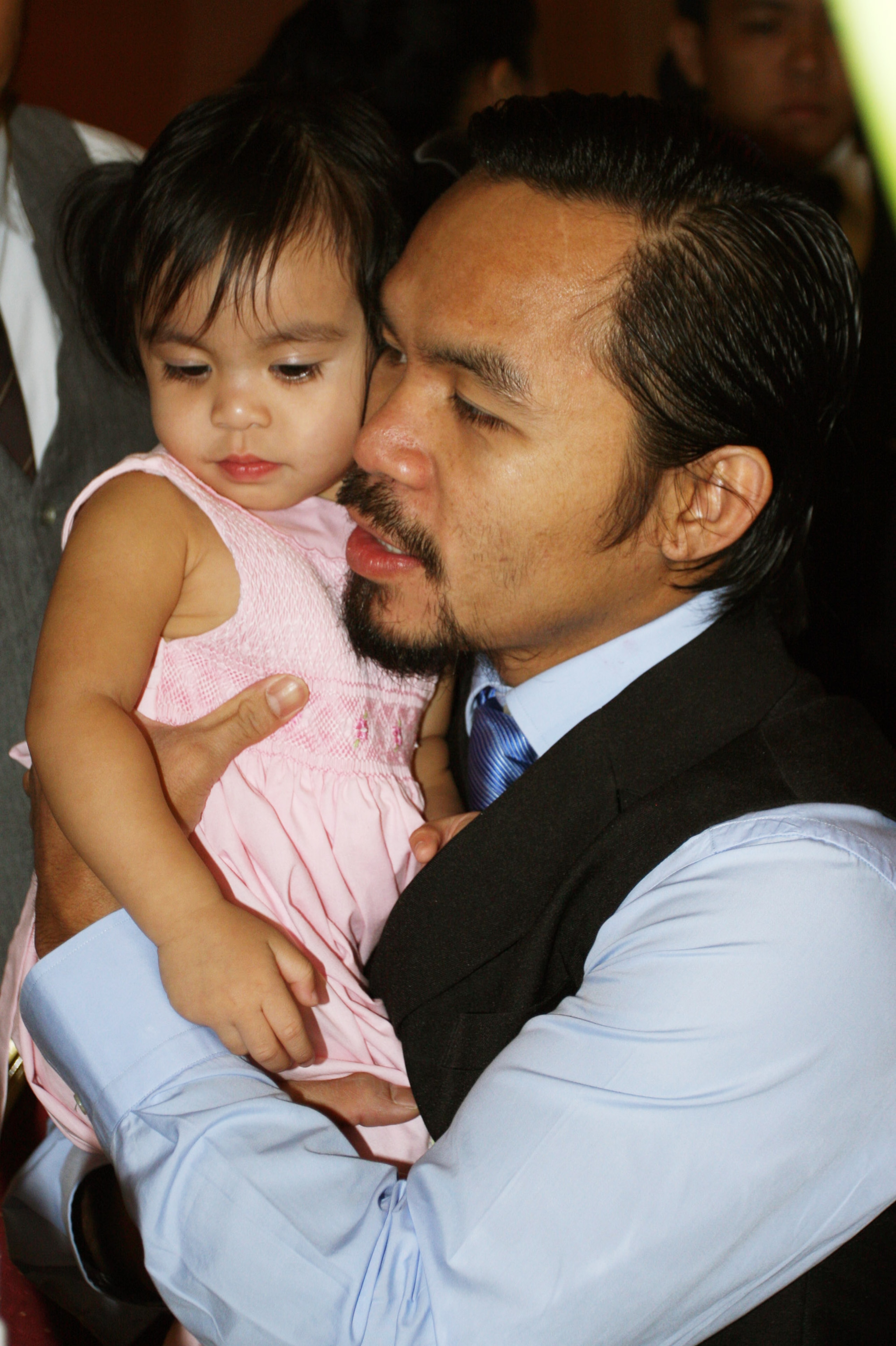 GENERAL SANTOS, PHILIPPINES - MAY 15:  World welterweight boxing champion Manny Pacquiao carries his daughter Queen  at the KCC Mall on May 15, 2010 in General Santos, Philippines. Pacquiao was there to celebrate his election on becoming a member of House