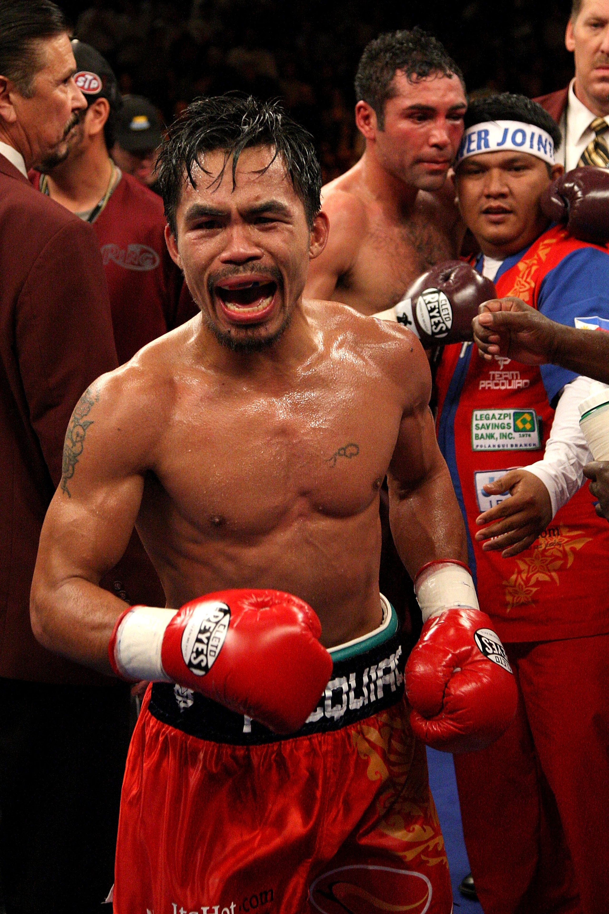 LAS VEGAS - DECEMBER 06:  (L-R) Manny Pacquiao of the Philippines celebrates after defeating Oscar De La Hoya in the eighth round by TKO in their welterweight fight at the MGM Grand Garden Arena December 6, 2008 in Las Vegas, Nevada.  (Photo by Jed Jacobs