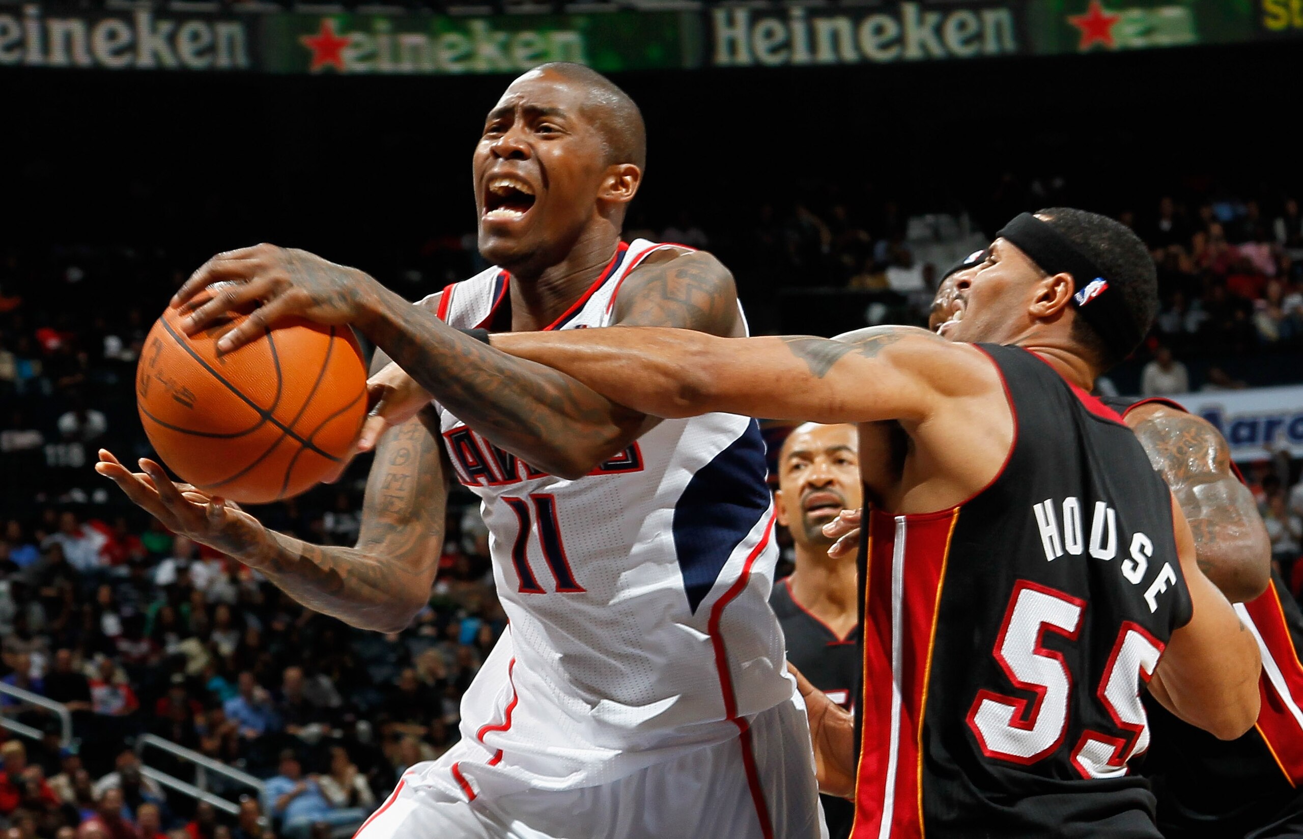 ATLANTA - OCTOBER 21:  Eddie House #55 of the Miami Heat fouls Jamal Crawford #11 of the Atlanta Hawks at Philips Arena on October 21, 2010 in Atlanta, Georgia.  (Photo by Kevin C. Cox/Getty Images)