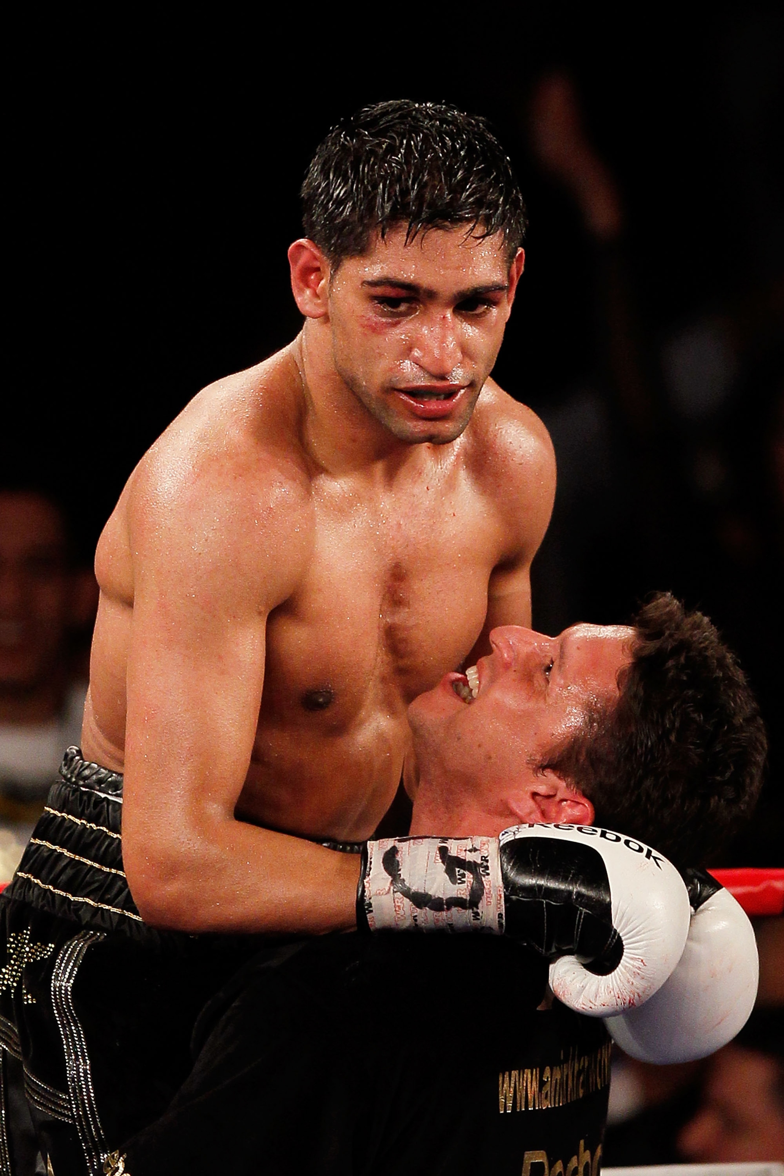 NEW YORK - MAY 15:  Amir Khan (L) of Great Britain celebrates with a trainer after defeating Paulie Malignaggi by TKO in the 11th round of his WBA light welterweight title fight at Madison Square Garden on May 15, 2010 in New York City.  (Photo by Chris T