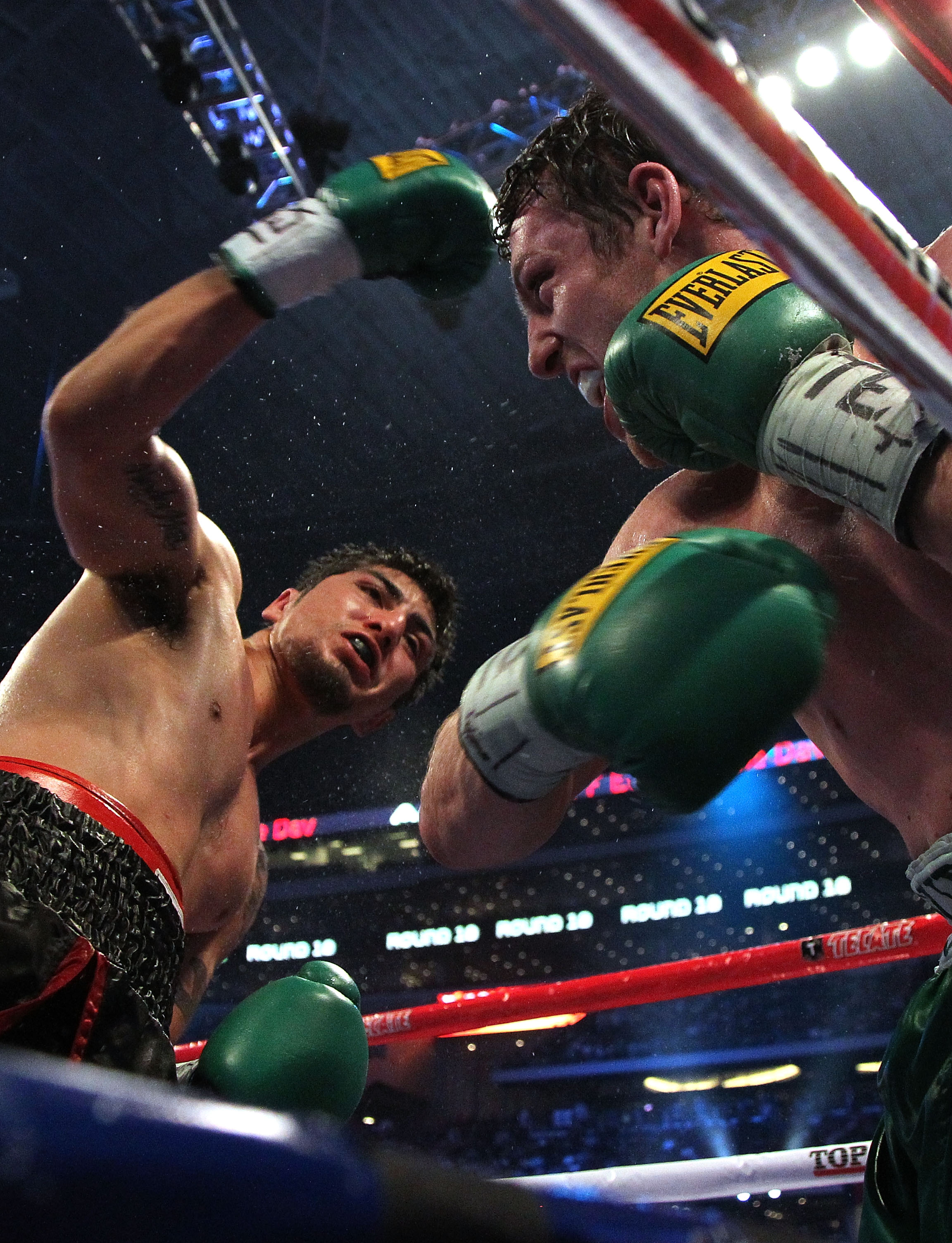 ARLINGTON, TX - MARCH 13:  (L-R) Michael Medina of Mexico throws a right to the face of John Duddy of Ireland during the middleweight fight at Cowboys Stadium on March 13, 2010 in Arlington, Texas. Duddy defeated Medina by split decision. (Photo by Jed Ja