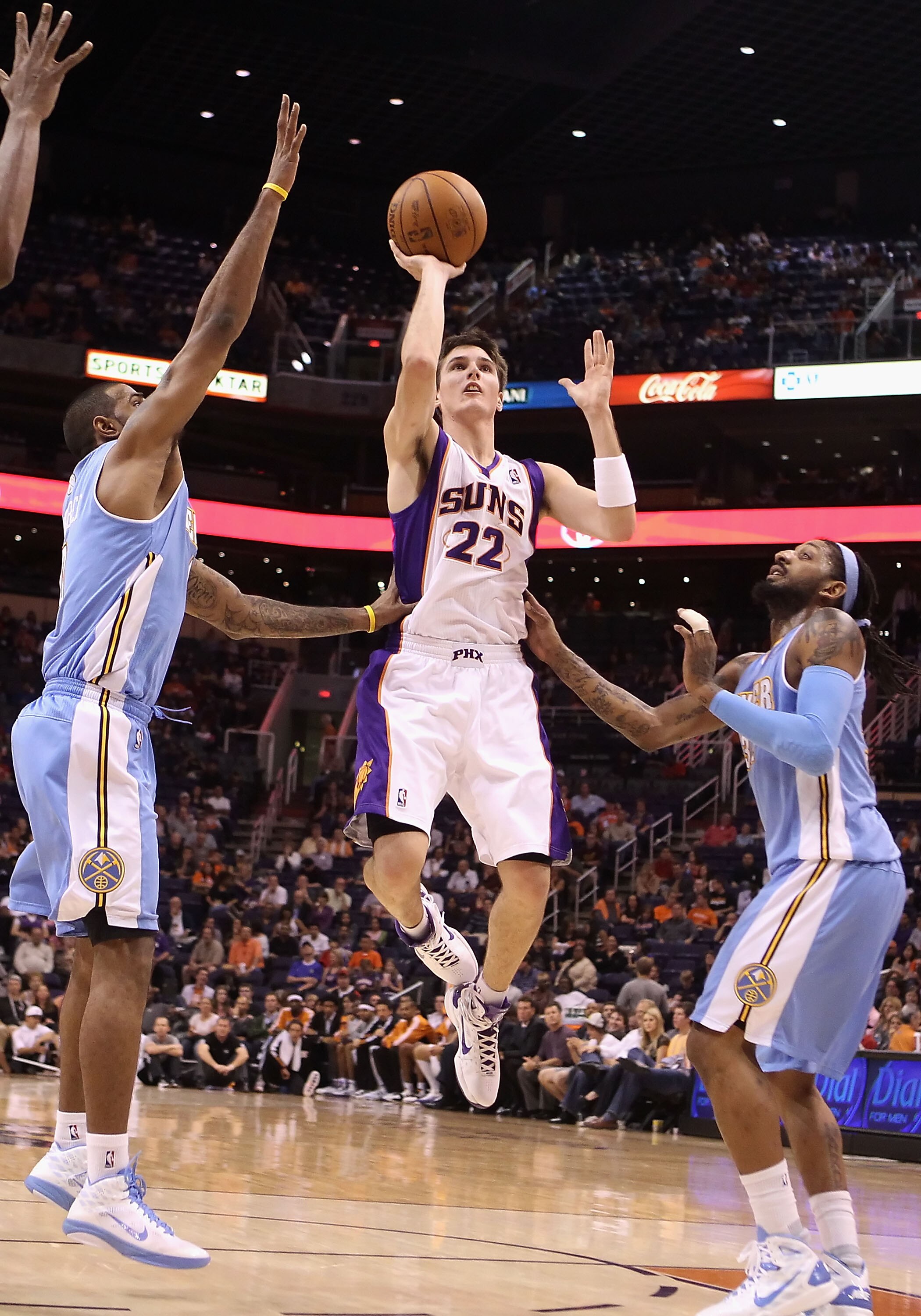 PHOENIX - OCTOBER 22:  Matt Janning #22 of the Phoenix Suns puts up a shot against the Denver Nuggets during the preseason NBA game at US Airways Center on October 22, 2010 in Phoenix, Arizona. NOTE TO USER: User expressly acknowledges and agrees that, by