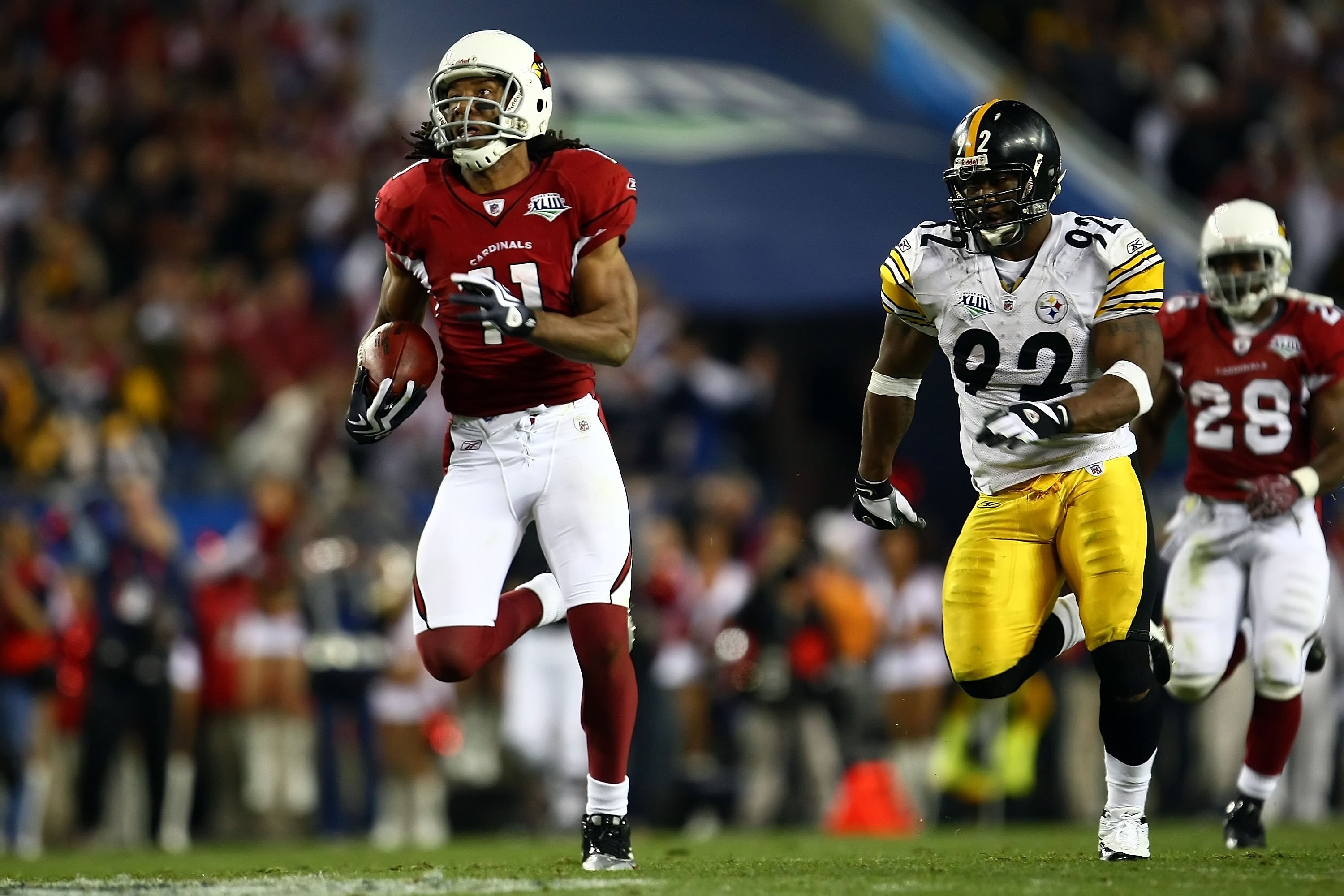 TAMPA, FL - FEBRUARY 01:  Larry Fitzgerald #11 of the Arizona Cardinals runs for a touchdown after a catch against James Harrison #92 of the Pittsburgh Steelers in the fourth quarter during Super Bowl XLIII on February 1, 2009 at Raymond James Stadium in