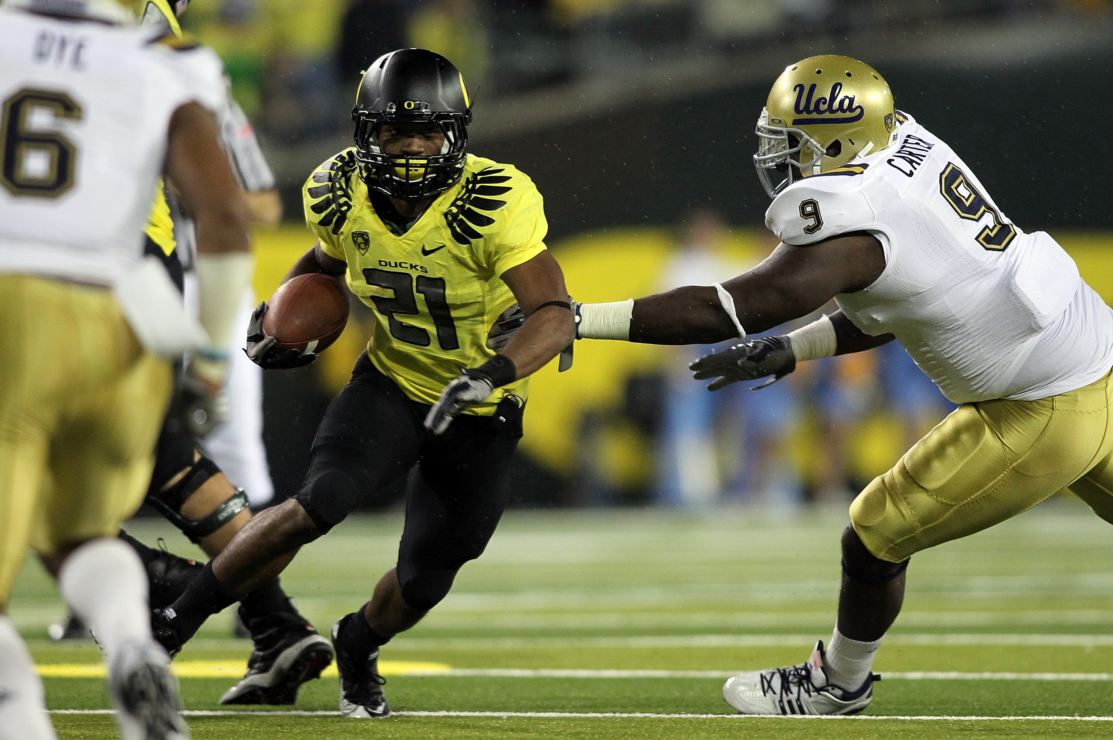 EUGENE, OR - OCTOBER 21:  LaMichael James #21 of the Oregon Ducks runs the ball against Donavan Carter #9 of the UCLA Bruins on October 21, 2010 at the Autzen Stadium in Eugene, Oregon.  (Photo by Jonathan Ferrey/Getty Images)