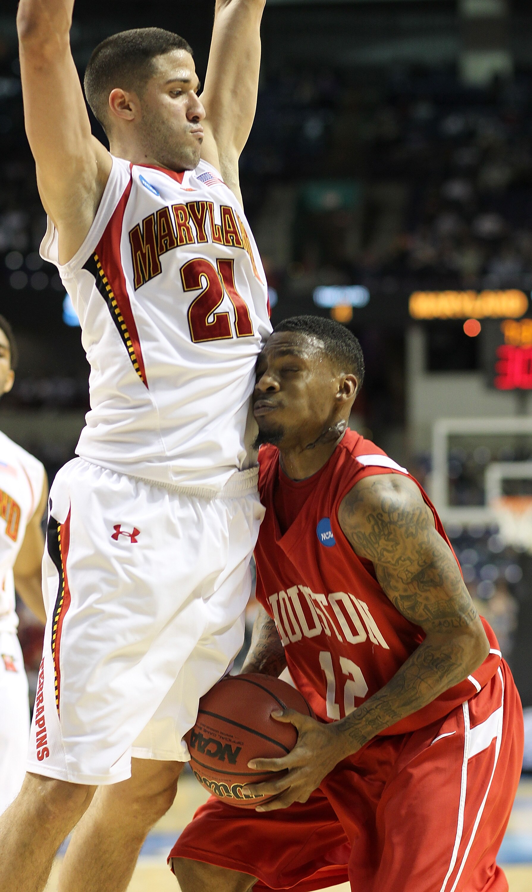 SPOKANE - MARCH 19:  Aubrey Coleman #12 of the Houston Cougars runs up against Greivis Vasquez #21 of the Maryland Terrapins during the first round of the 2010 NCAA men's basketball tournament at the Spokane Arena on March 19, 2010 in Spokane, Washington.
