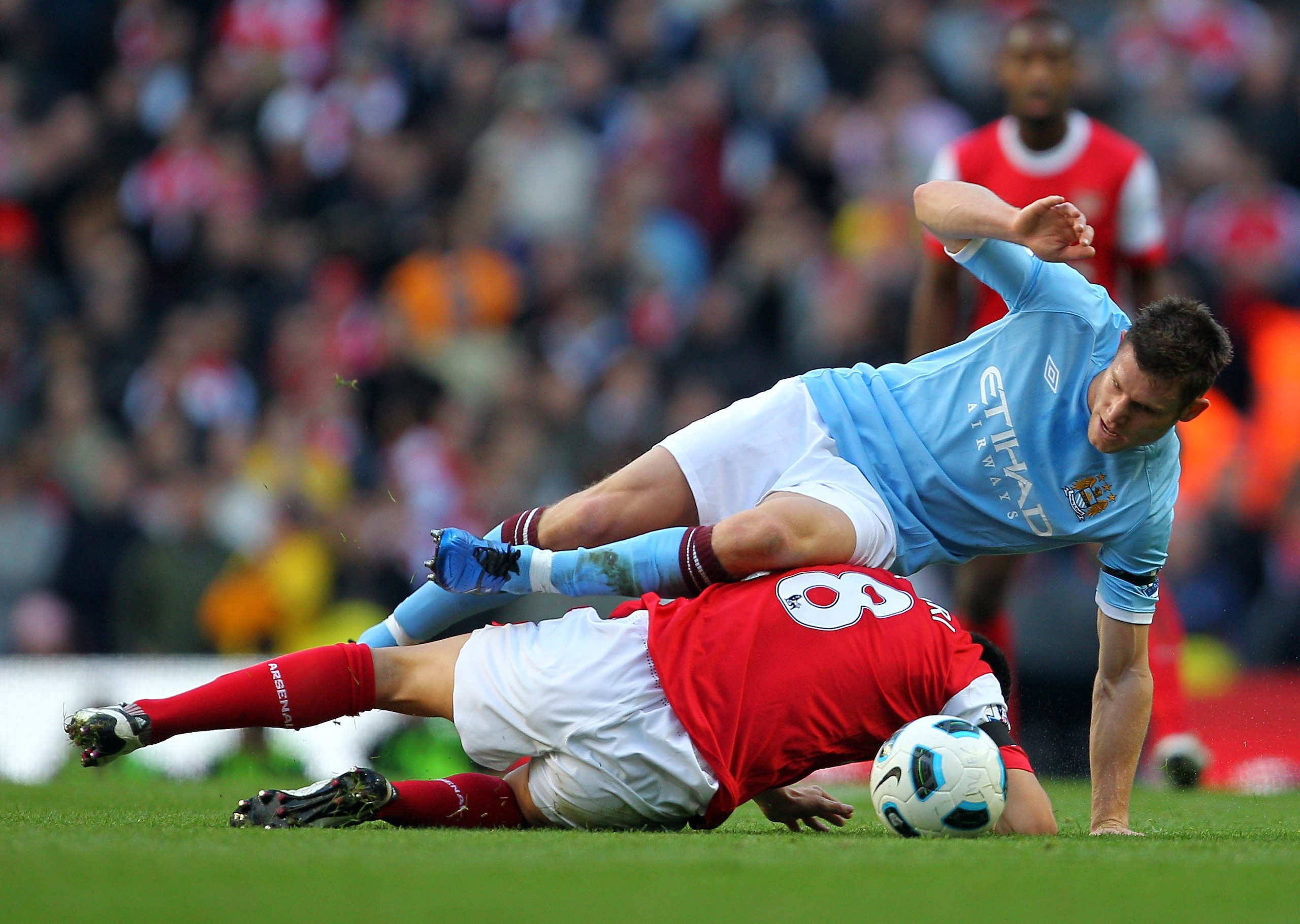 MANCHESTER, ENGLAND - OCTOBER 24:  James Milner of Manchester City is tackled by Samir Nasri of Arsenal during the Barclays Premier League match between Manchester City and Arsenal at City of Manchester Stadium on October 24, 2010 in Manchester, England.