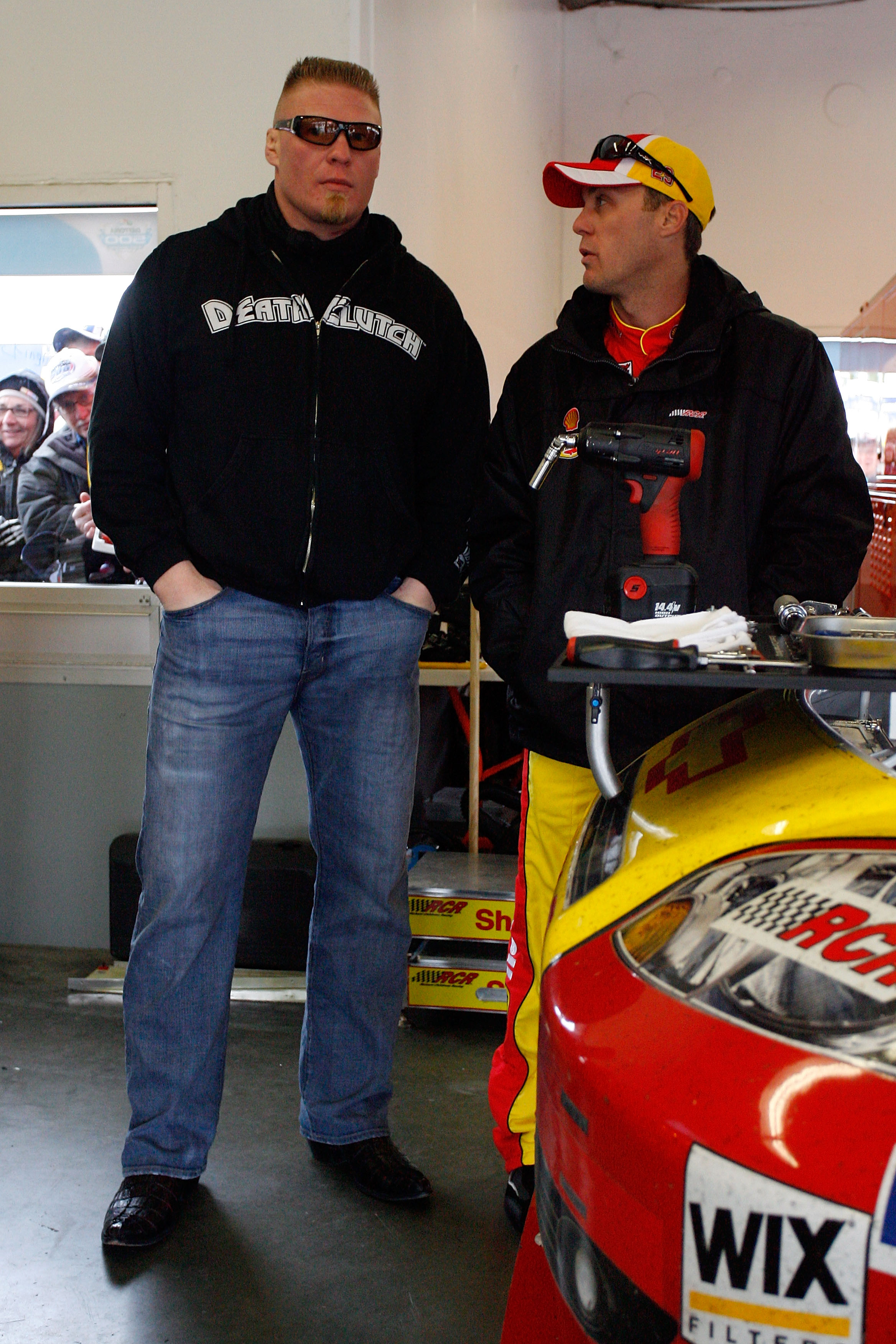 DAYTONA BEACH, FL - FEBRUARY 13:  MMA fighter Brock Lesnar speaks with Kevin Harvick, driver of the #29 Shell/Pennzoil Chevrolet, during practice for the Daytona 500 at Daytona International Speedway on February 13, 2010 in Daytona Beach, Florida.  (Photo