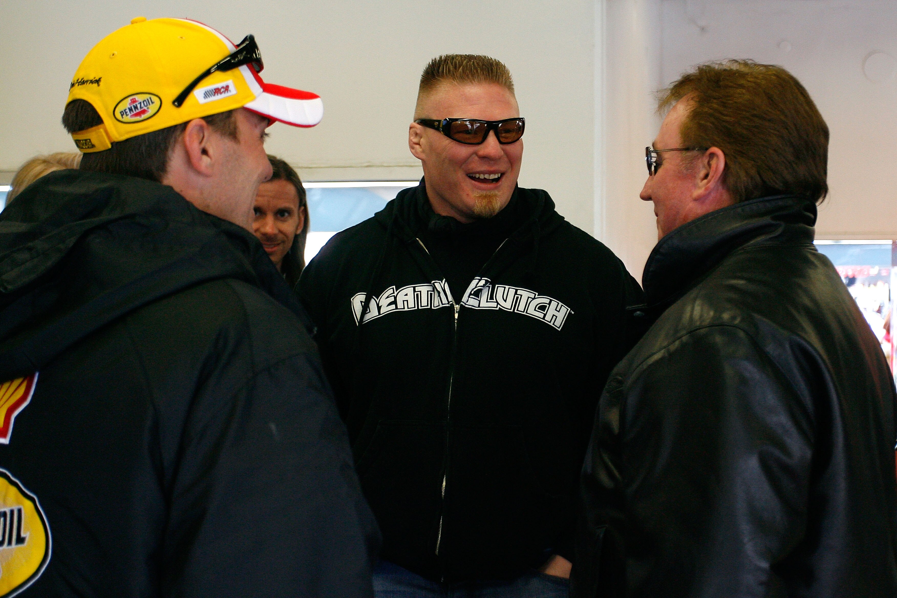 DAYTONA BEACH, FL - FEBRUARY 13:  MMA fighter Brock Lesnar(C)  speaks with Kevin Harvick(L), driver of the #29 Shell/Pennzoil Chevrolet, and team owner Richard Childress during practice for the Daytona 500 at Daytona International Speedway on February 13,