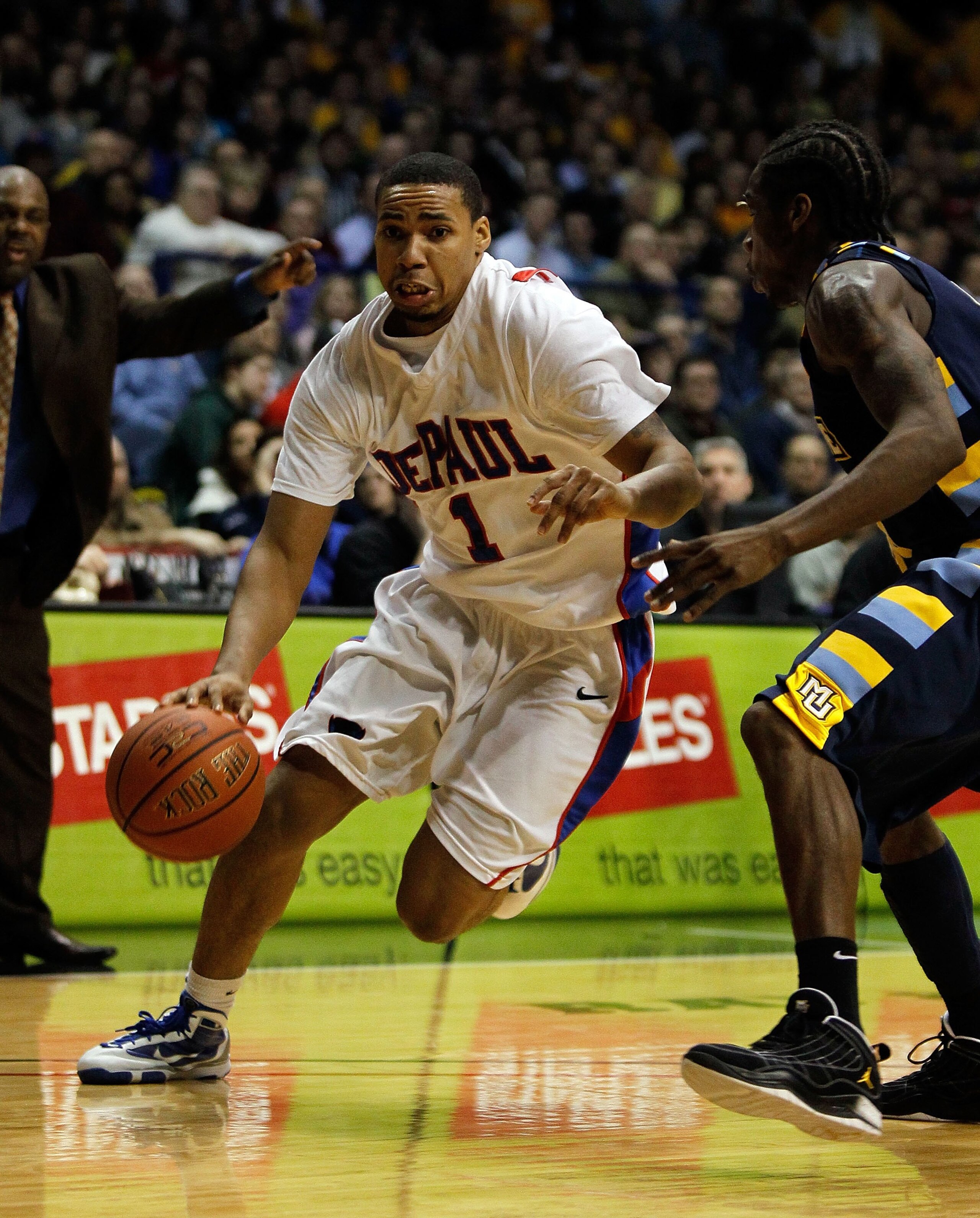 ROSEMONT, IL - JANUARY 20: Mike Stovall #1 of the DePaul Blue Demons moves past Dwight Buycks #23 of the Marquette Golden Eagles at the Allstate Arena on January 20, 2010 in Rosemont, Illinois. DePaul defeated Marquette 51-50. (Photo by Jonathan Daniel/Ge