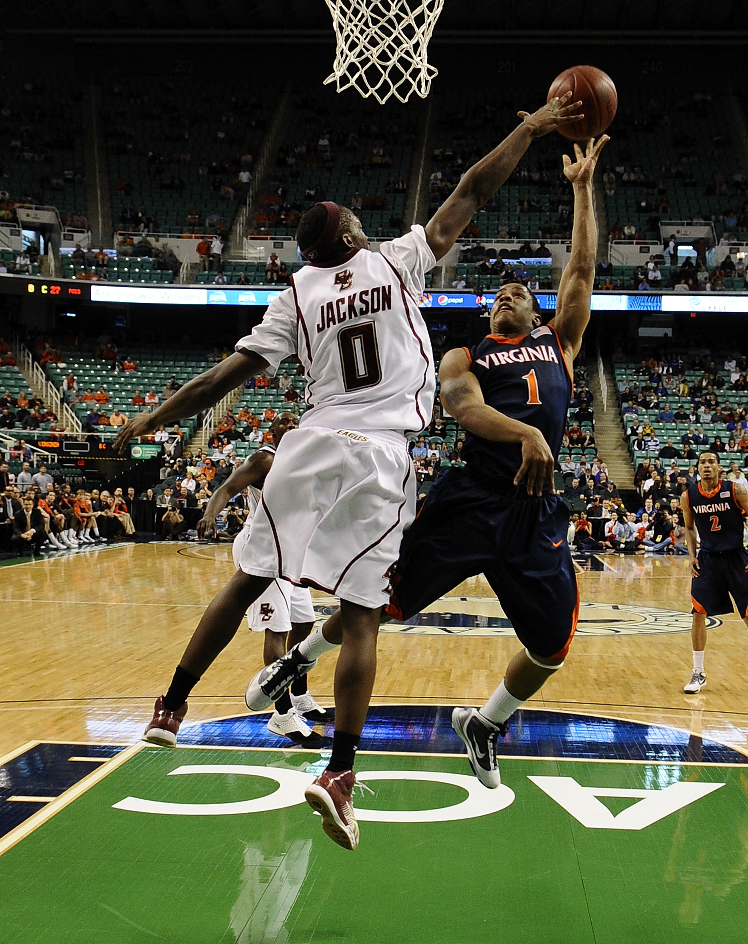 GREENSBORO, NC - MARCH 11:  Reggie Jackson #0 of the Boston College Eagles blocks a shot by Jontel Evans #1 of the University of Virginia Cavaliers in their first round game in the 2010 ACC Men's Basketball Tournament at the Greensboro Coliseum on March 1