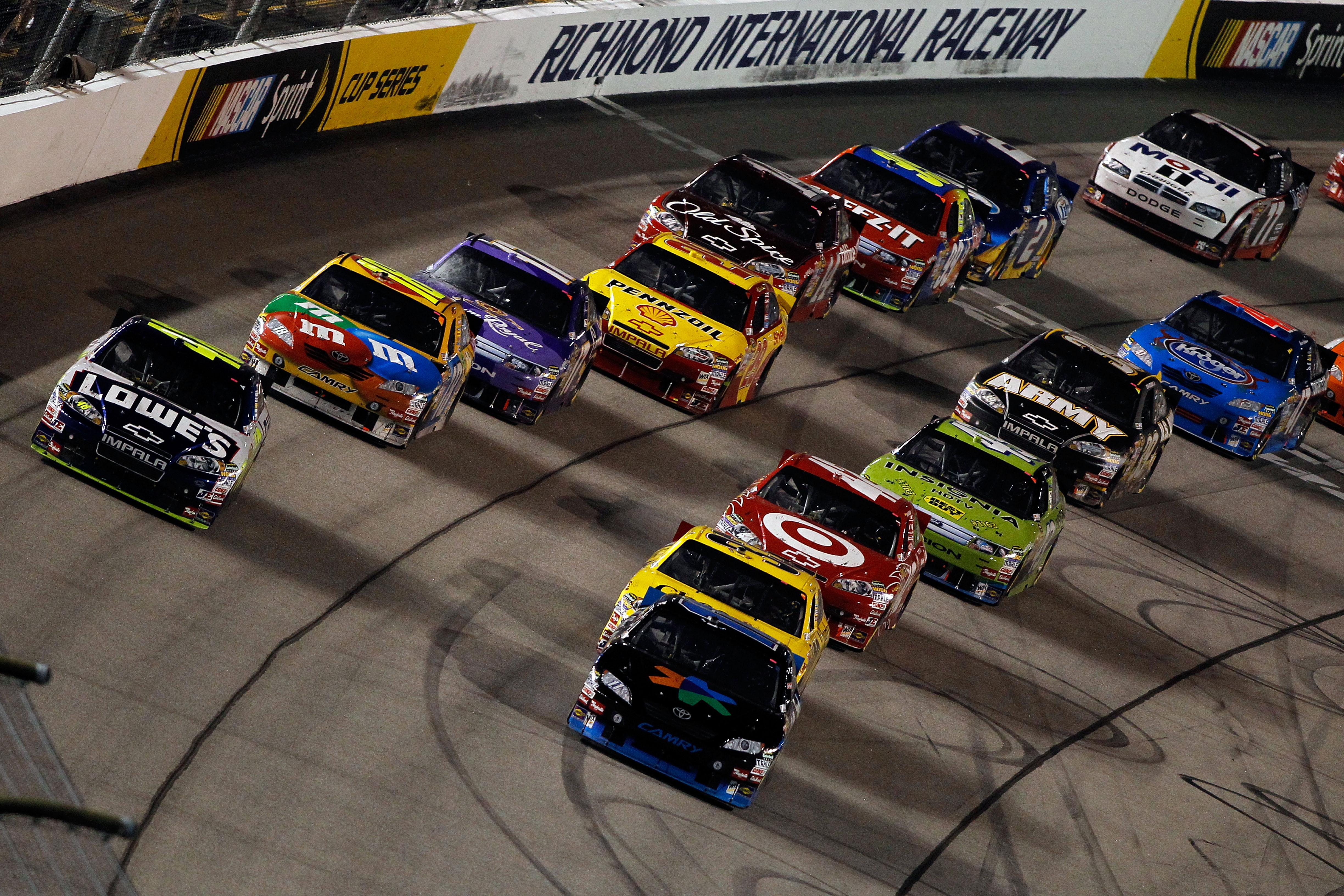 RICHMOND, VA - SEPTEMBER 11:  Jimmie Johnson, driver of the #48 Lowe's Chevrolet,  and Denny Hamlin, driver of the #11 FedEx Office Toyota, lead the field to a restart in the NASCAR Sprint Cup Series Air Guard 400 at Richmond International Raceway on Sept