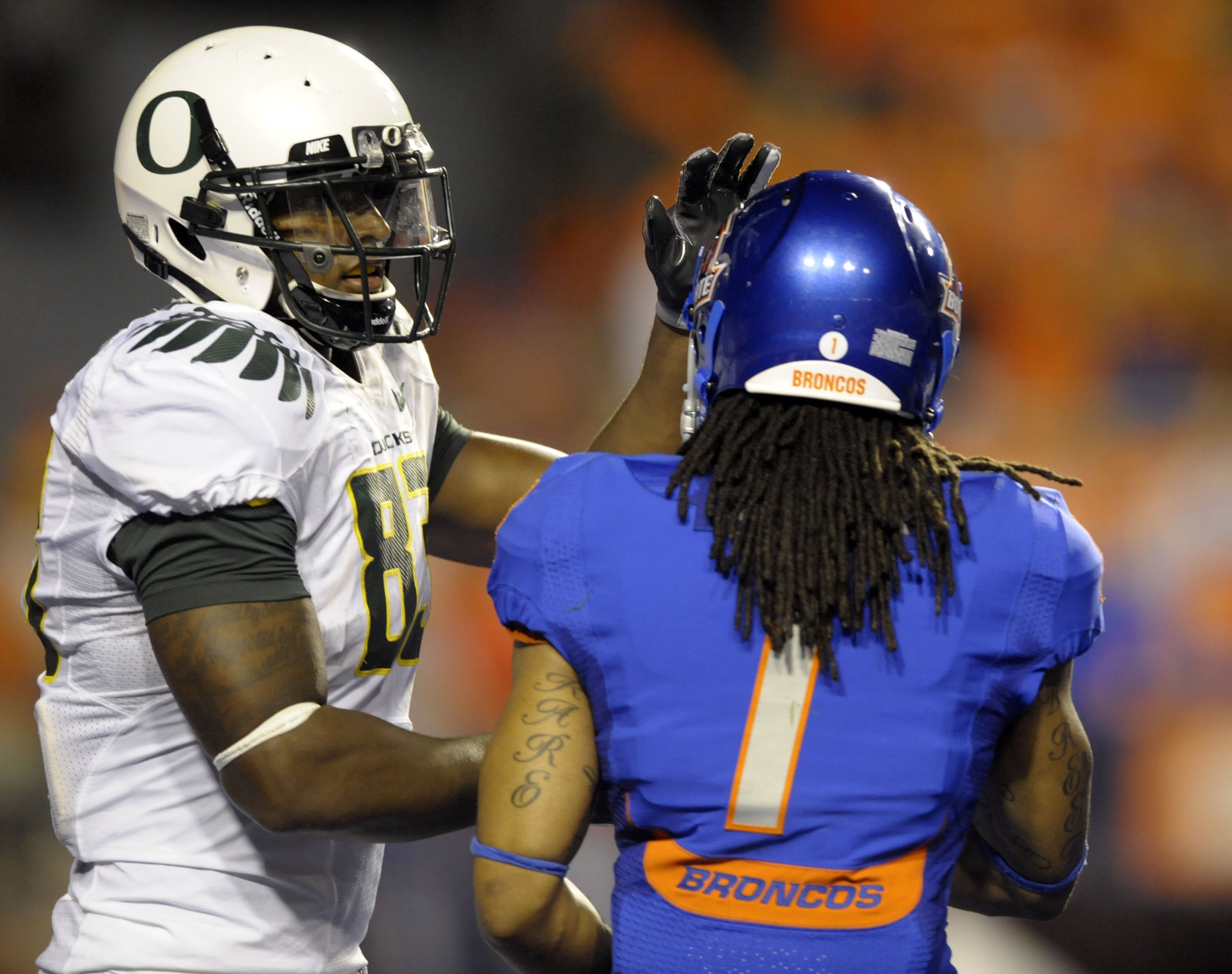 BOISE, ID - SEPTEMBER 3: Tight end Ed Dickson #83  of the Oregon Ducks congratulates cornerback Kyle Wilson #1 of the Boise State Broncos after a play in the third quarter of the game on September 3, 2009 at Bronco Stadium in Boise, Idaho. Boise State won