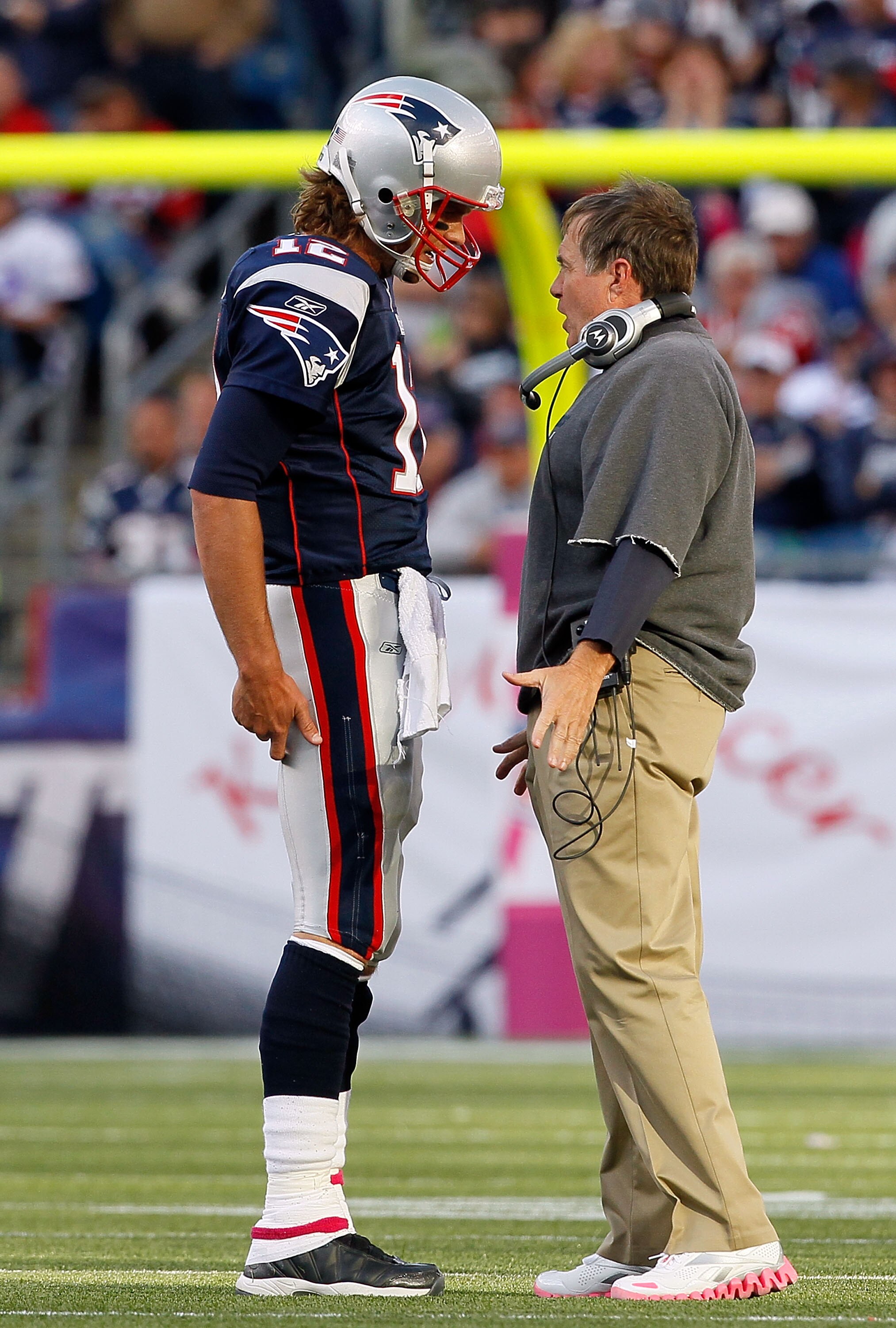 FOXBORO, MA - OCTOBER 17:  Coach Bill Belichick of the New England Patriots talks to his quarterback Tom Brady during a game against the Baltimore Ravens at Gillette Stadium on October 17, 2010 in Foxboro, Massachusetts. (Photo by Jim Rogash/Getty Images)