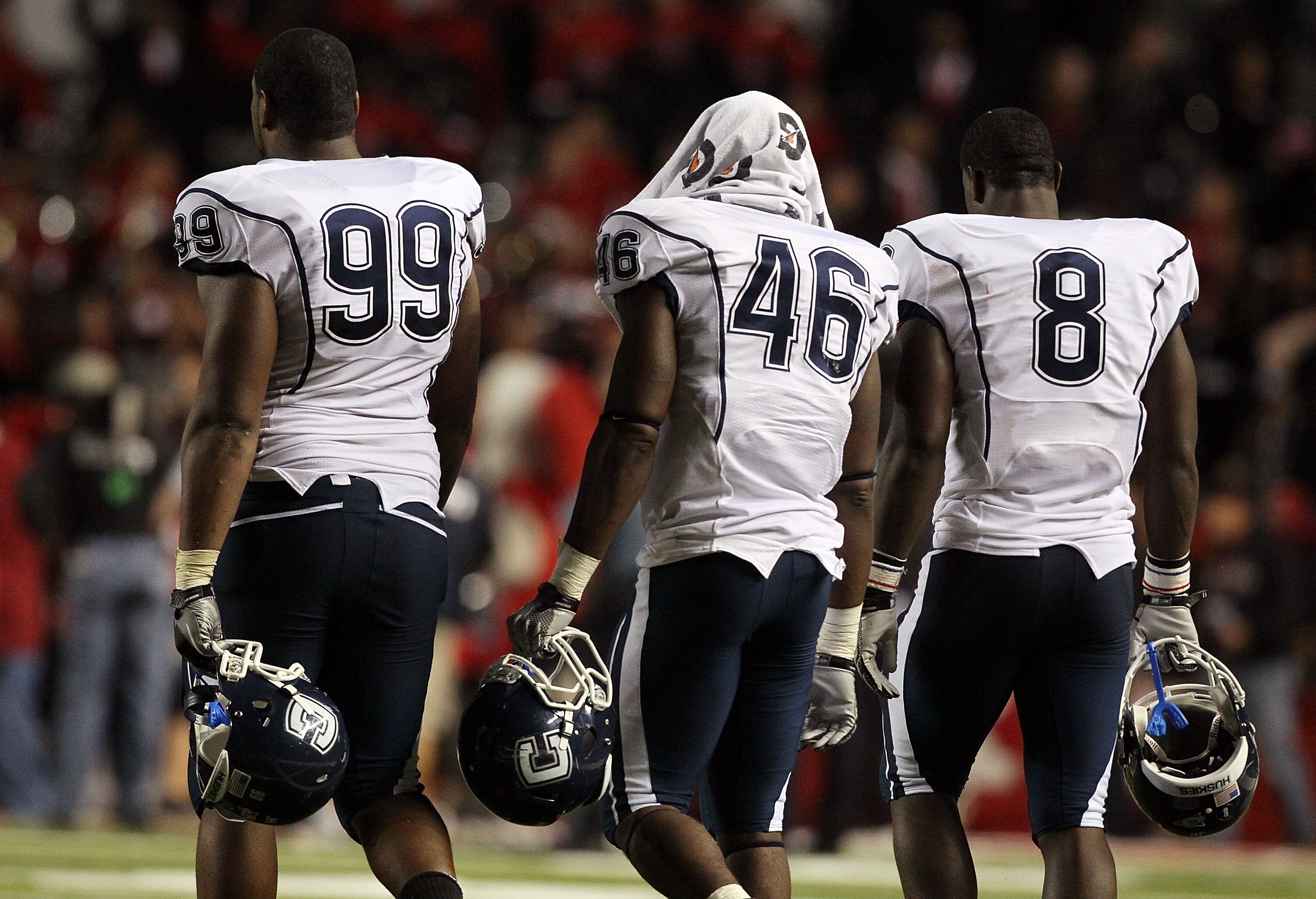 PISCATAWAY, NJ - OCTOBER 08:  Kendall Reyes #99, Sio Moore #46 and Lawrence Wilson #8 of the Connecticut Huskies walk off the field after losing against the Rutgers Scarlet Knights at Rutgers Stadium on October 8, 2010 in Piscataway, New Jersey. Rutgers d