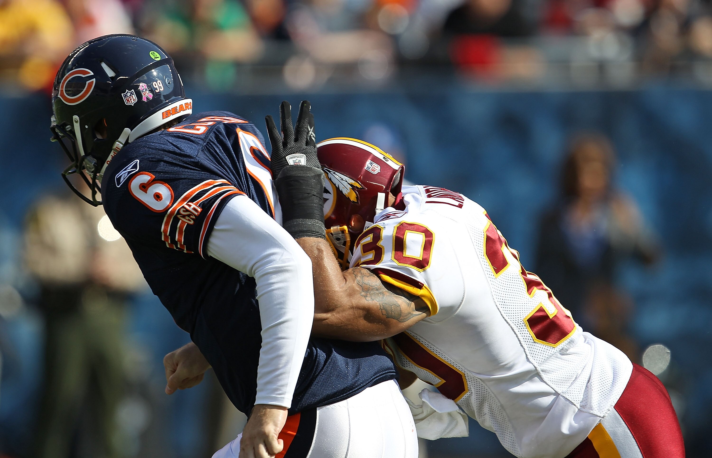 CHICAGO - OCTOBER 24: Jay Cutler #6 of the Chicago Bears is hit in the back by LaRon Landry #30 of the Washington Redskins after passing at Soldier Field on October 24, 2010 in Chicago, Illinois. (Photo by Jonathan Daniel/Getty Images)