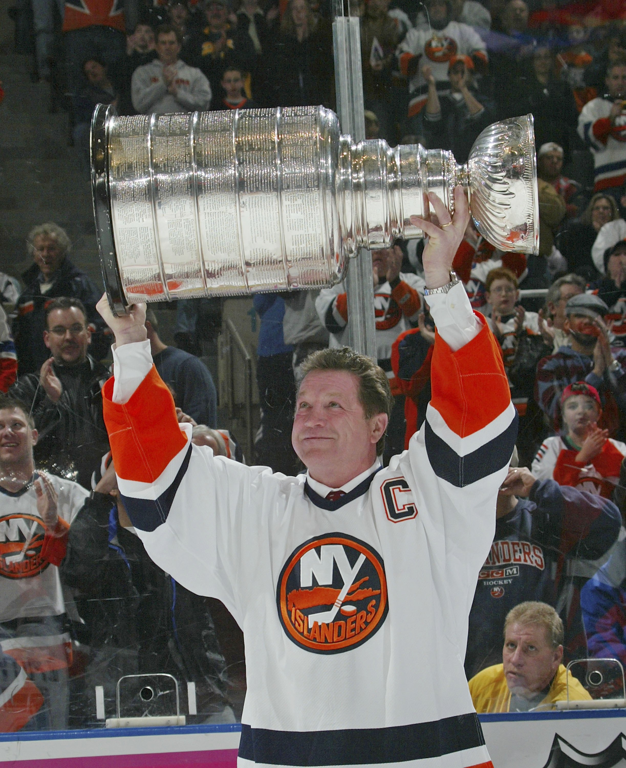 UNIONDALE, NY - MARCH 4:  Denis Potvin #5, formerly of the New York Islanders, holds up the Stanley Cup during a ceremony honoring the 25th anniversary of the Islanders first Stanley Cup victory held on March 4, 2006 at the Nassau Coliseum in Uniondale, N