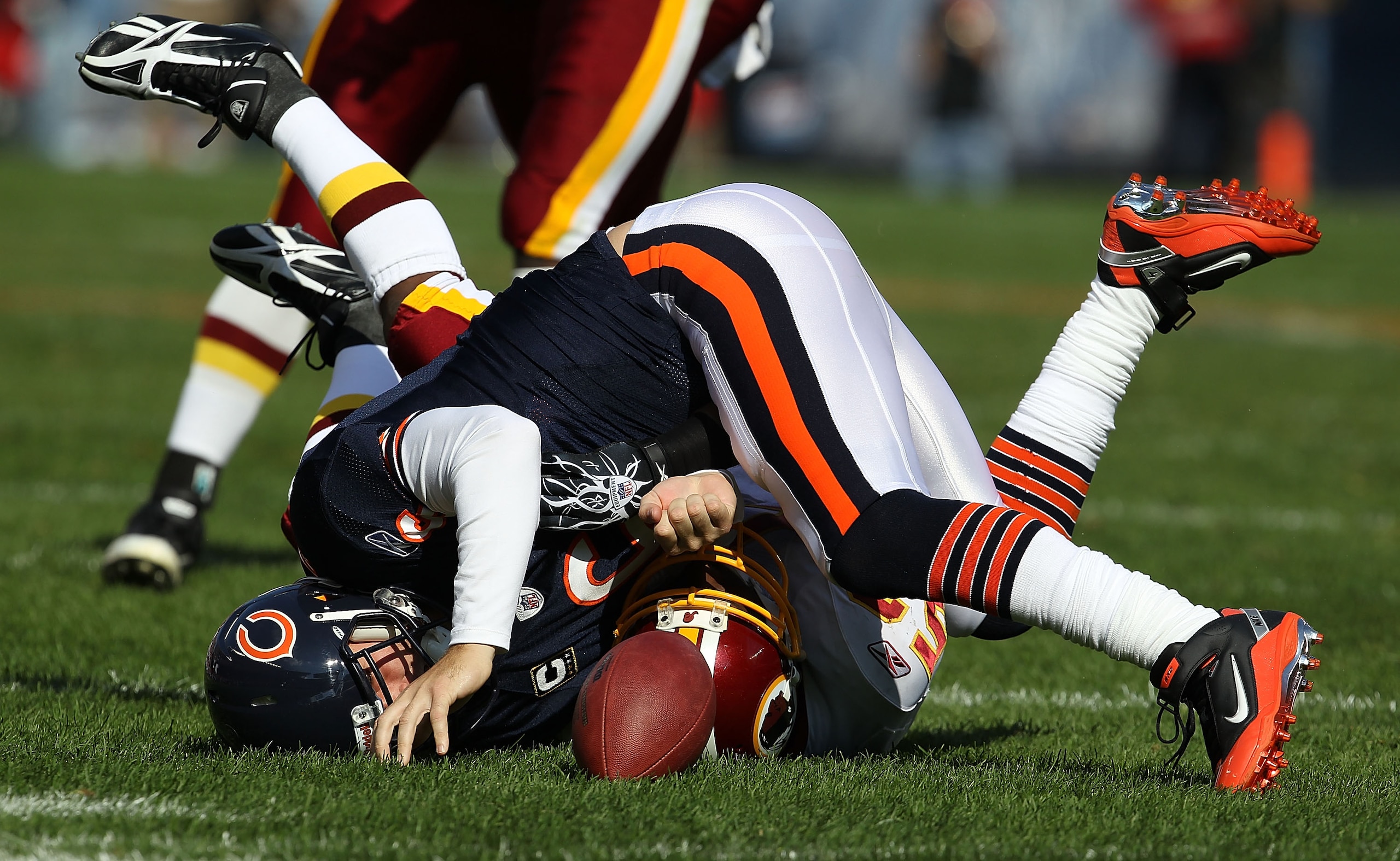CHICAGO - OCTOBER 24: Jay Cutler #6 of the Chicago Bears hits the ground after being sacked by Rocky McIntosh #52 of the Washington Redskins at Soldier Field on October 24, 2010 in Chicago, Illinois.  (Photo by Jonathan Daniel/Getty Images)