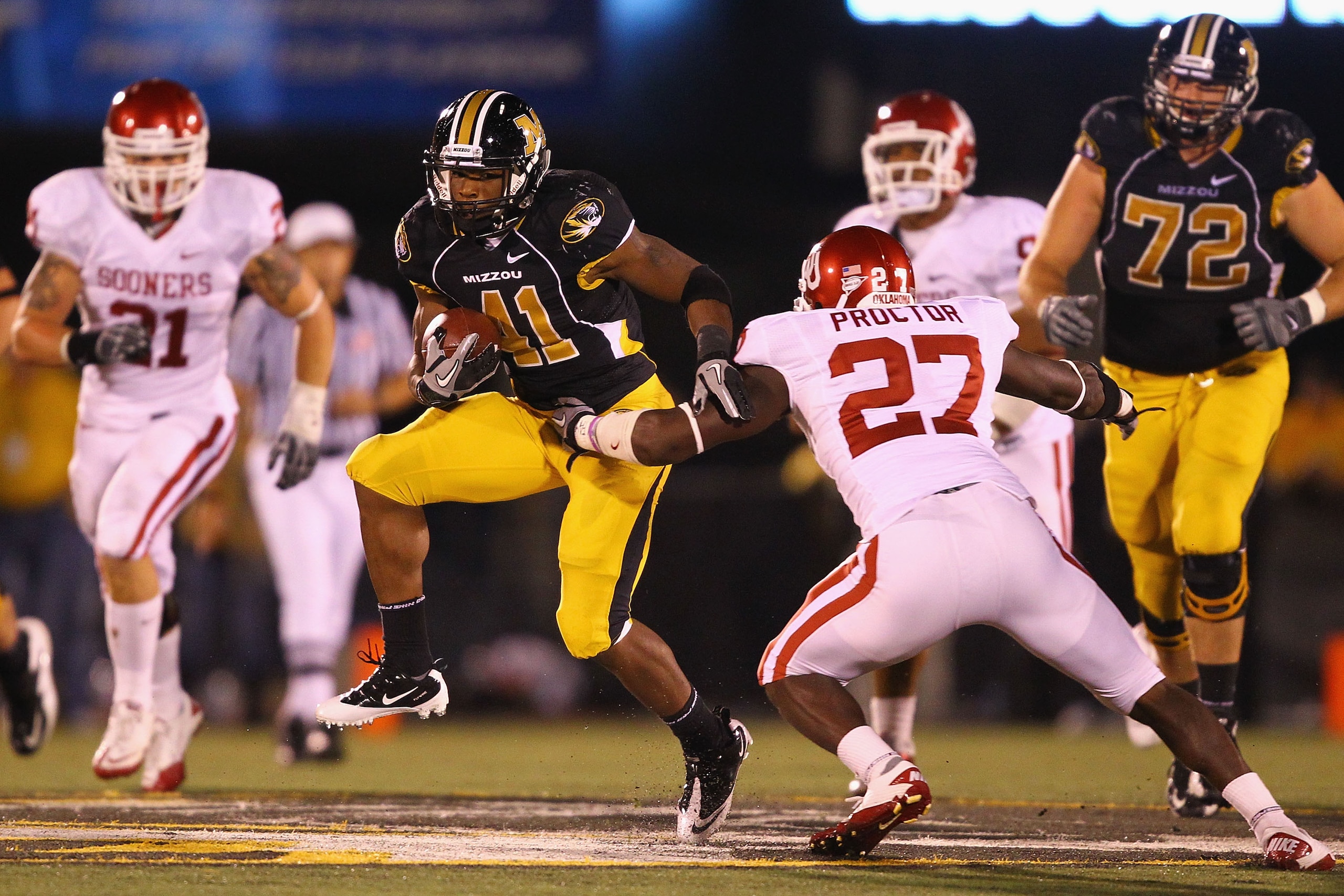 COLUMBIA, MISSOURI - OCTOBER 23: Henry Josey #41 of the Missouri Tigers gets past Sam Proctor #27 of the Oklahoma Sooners at Faurot Field/Memorial Stadium on October 23, 2010 in Columbia, Missouri.  The Tigers beat the Sooners 36-27.  (Photo by Dilip Vish
