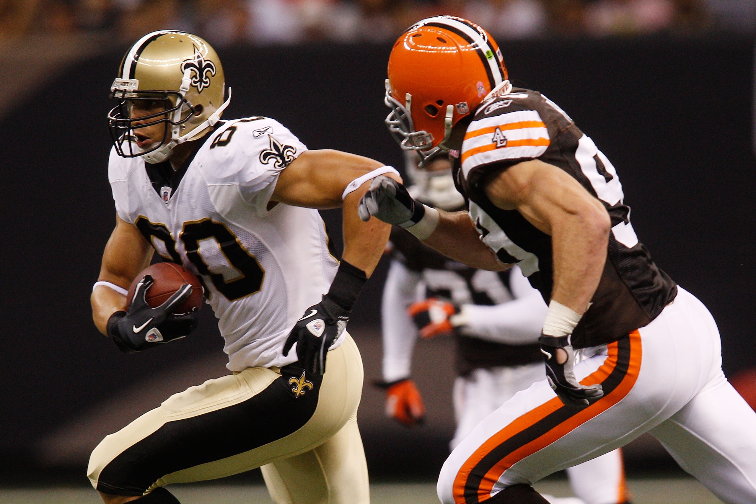 NEW ORLEANS - OCTOBER 24: Jimmy Graham #80 of the New Orleans Saints runs past Scott Fujita #99  of the Cleveland Browns at the Louisiana Superdome on October 24, 2010 in New Orleans, Louisiana.  (Photo by Chris Graythen/Getty Images)