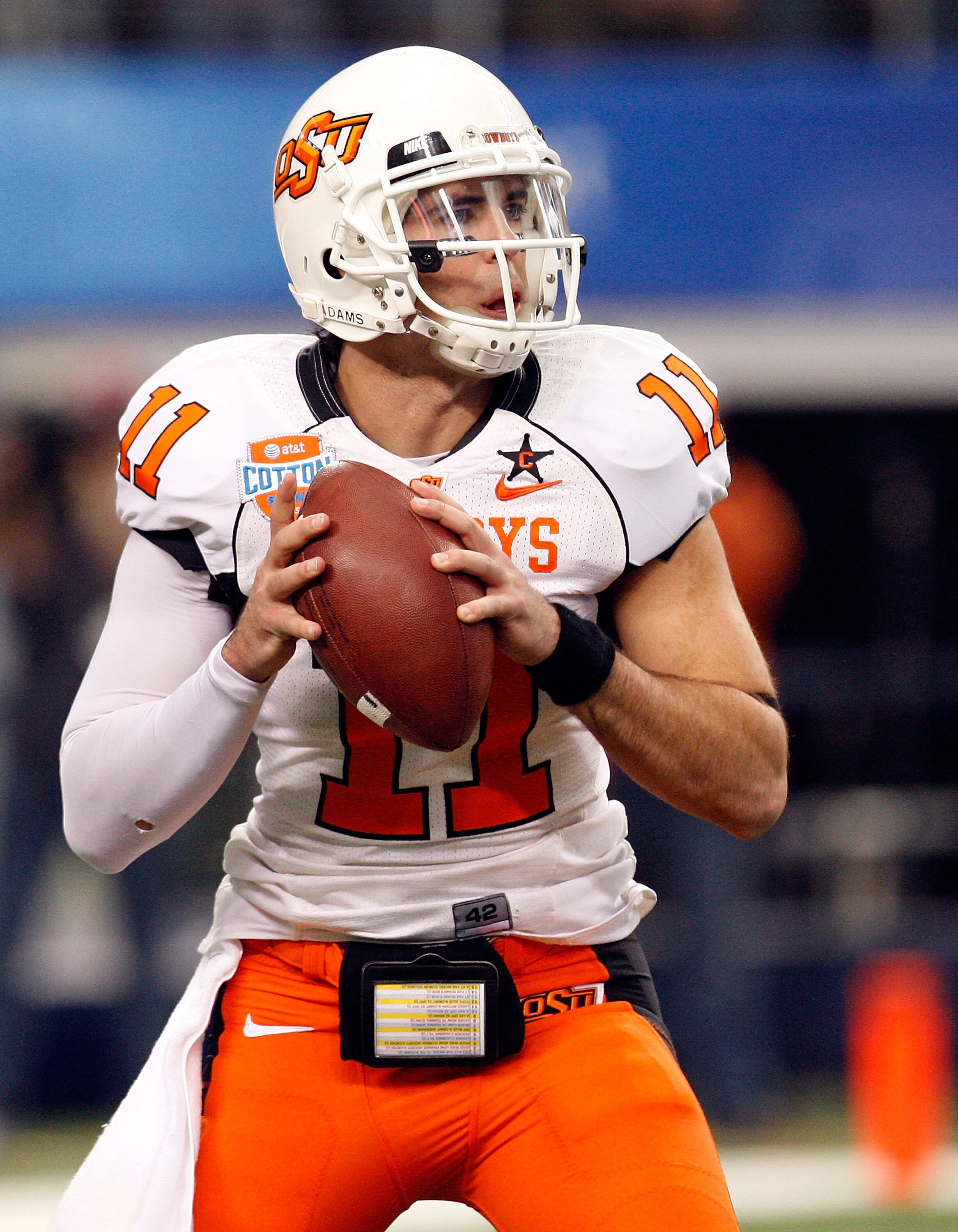 ARLINGTON, TX - JANUARY 02:  Quarterback Zac Robinson #11 of the Oklahoma State Cowboys drops back to pass against the Mississippi Rebels during the AT&T Cotton Bowl on January 2, 2010 at Cowboys Stadium in Arlington, Texas.  (Photo by Ronald Martinez/Get