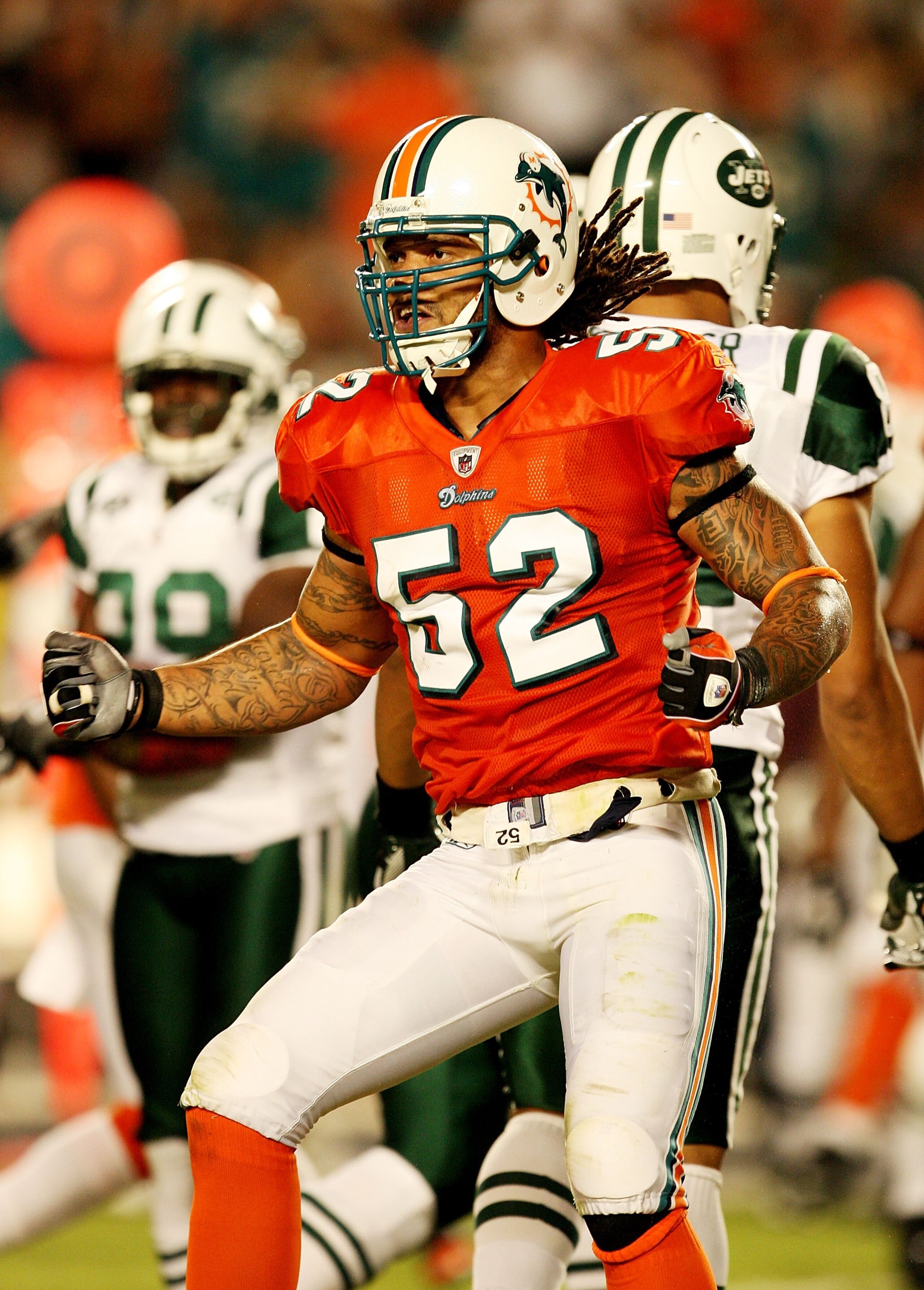MIAMI - OCTOBER 12:  Linebacker Channing Crowder #52 of the Miami Dolphins celebrates after making a tackle for a loss against the New York Jets at Land Shark Stadium on October 12, 2009 in Miami, Florida. The Dolphins defeated the Jets 31-27.  (Photo by 