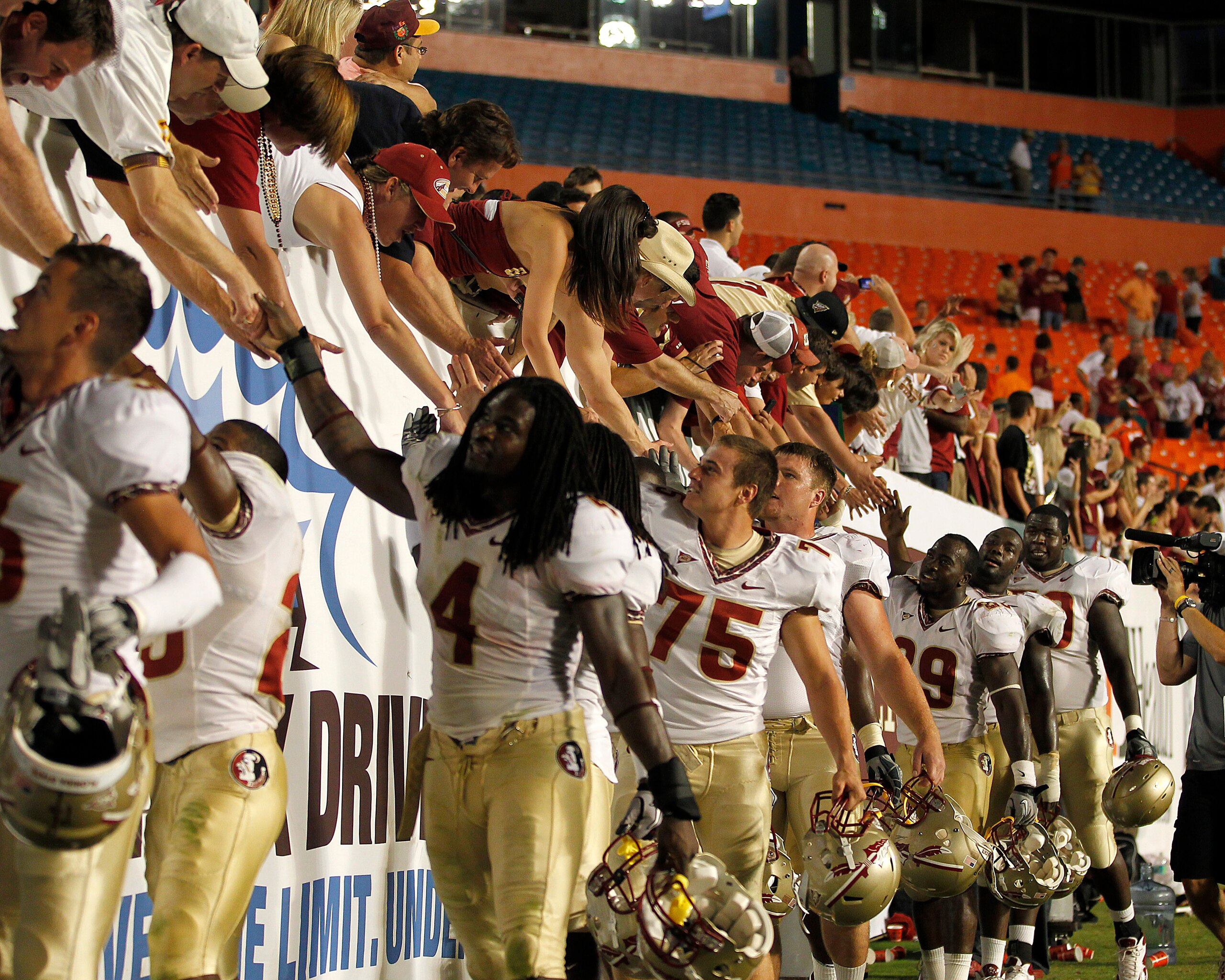 MIAMI, FL - OCTOBER 9: Florida State Seminoles fans celebrate the 45-17 victory against the Miami Hurricanes with members of the team on October 9, 2010 at Sun Life Stadium in Miami, Florida. (Photo by Joel Auerbach/Getty Images)