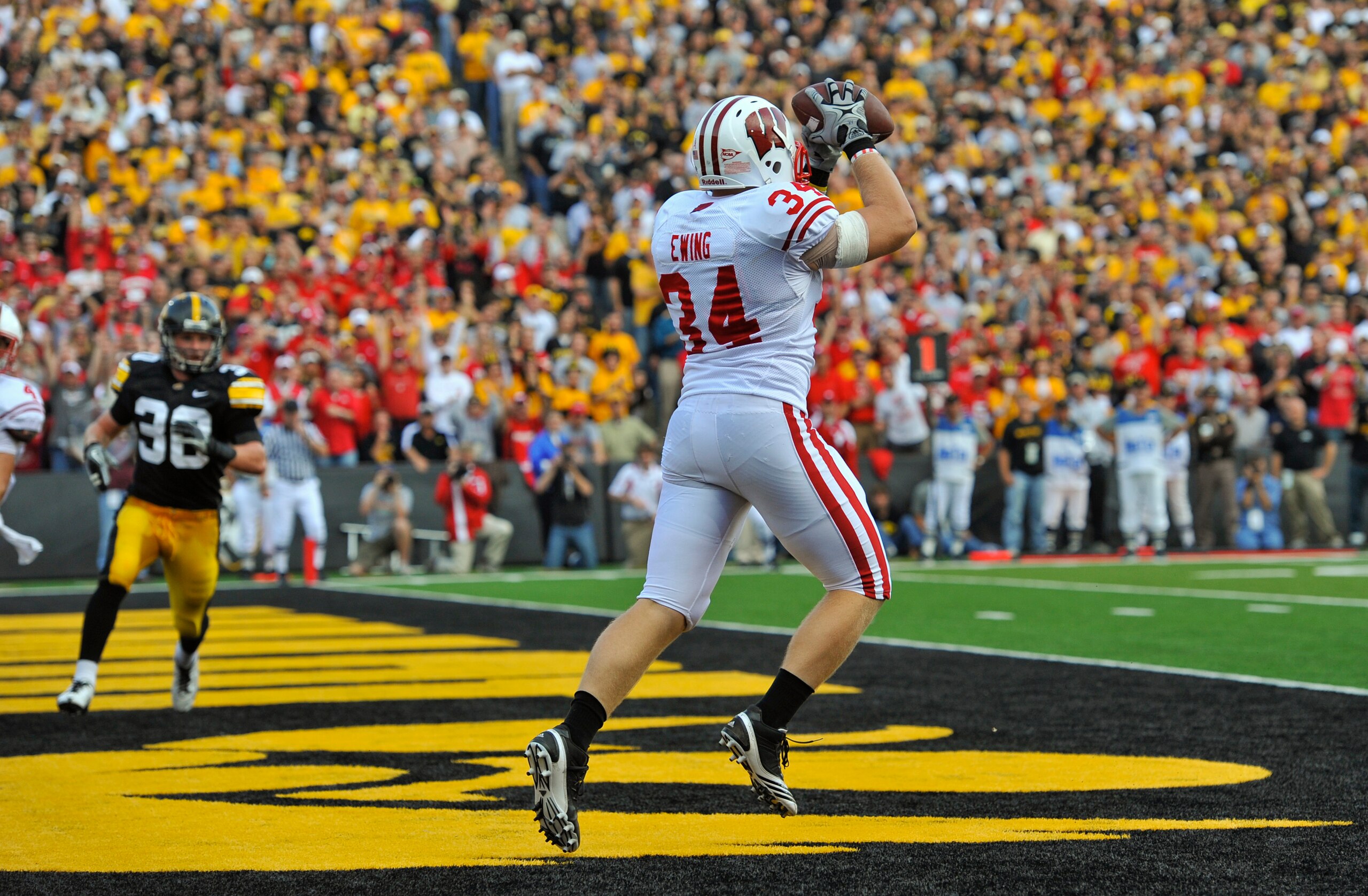 IOWA CITY, IA - OCTOBER 23- Running back Bradie Ewing #34 of the Wisconsin Badgers catches a touchdown pass during the first half of play against the University of Iowa Hawkeyes at Kinnick Stadium on October 23, 2010 in Iowa City, Iowa. Wisconsin won 31-3