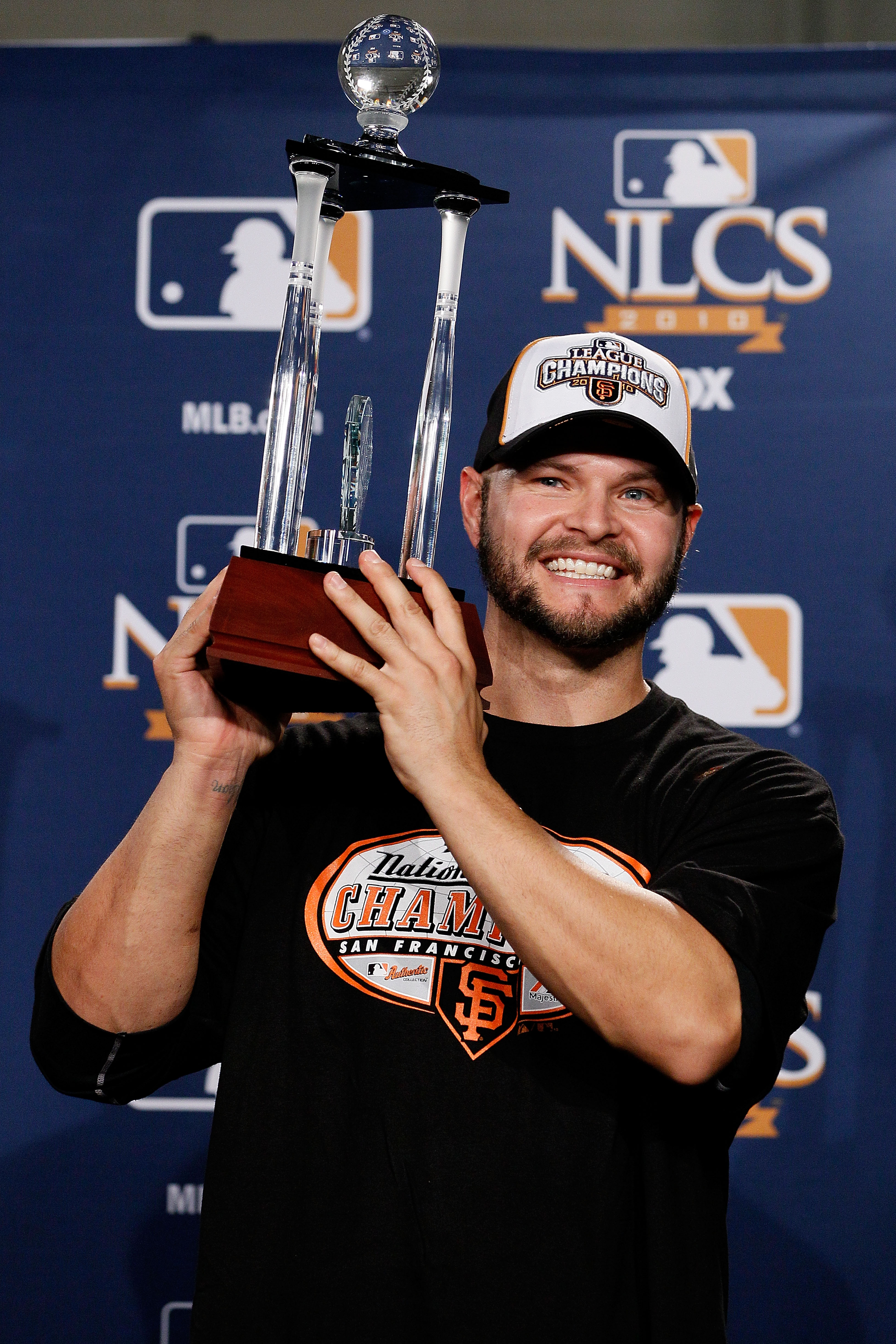 PHILADELPHIA - OCTOBER 23:  Cody Ross #13 of the San Francisco Giants celebrates with the NCLS MVP trophy after defeating the Philadelphia Phillies 3-2 and winning the pennant in Game Six of the NLCS during the 2010 MLB Playoffs at Citizens Bank Park on O