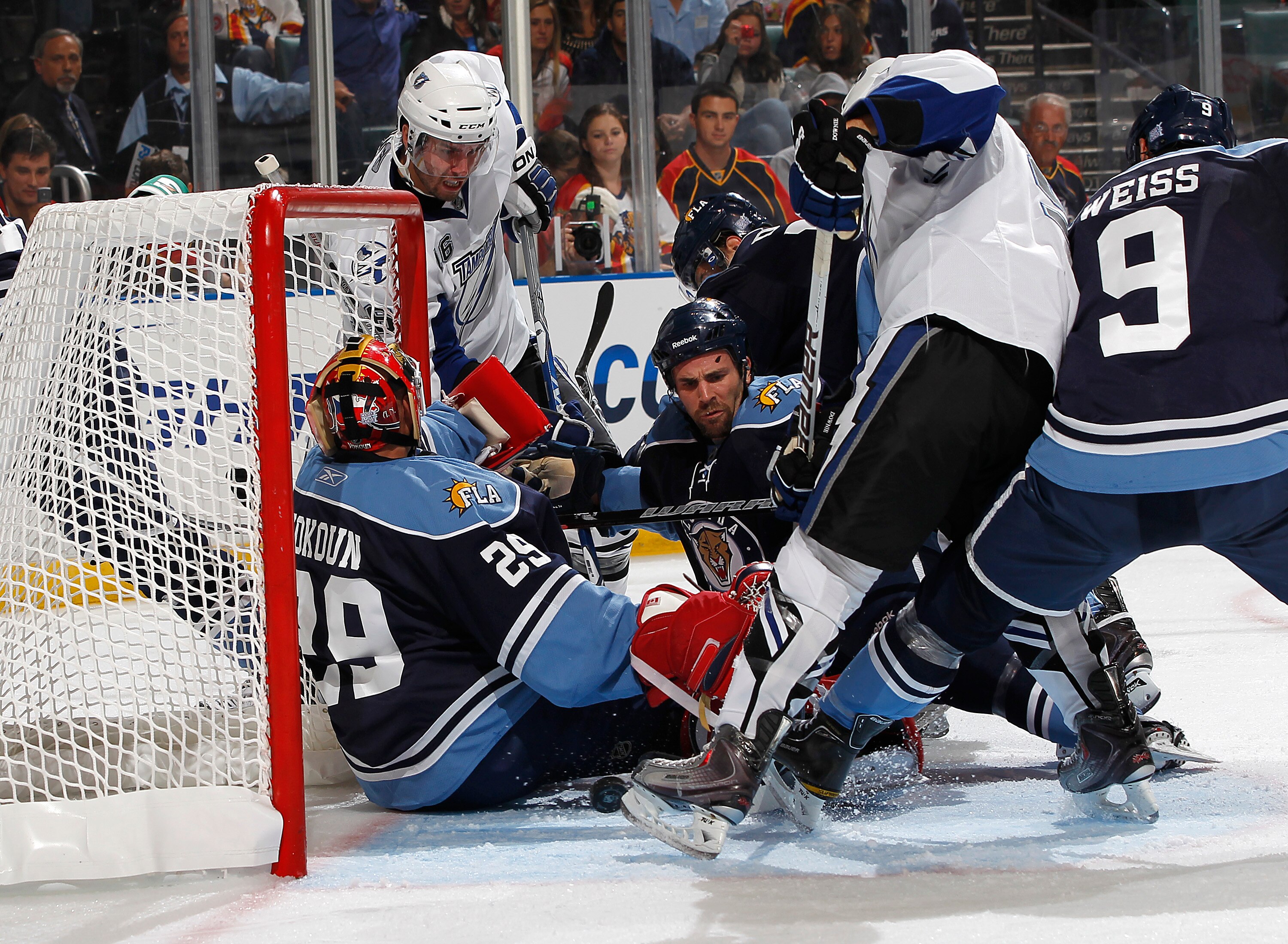 SUNRISE, FL - OCTOBER 16: Teddy Purcell #16 and Steve Downie #9 of the Tampa Bay Lightning cannot get control of the puck as goaltender Tomas Vokoun #29 of the Florida Panthers makes a save on October 16, 2010 at the BankAtlantic Center in Sunrise, Florid