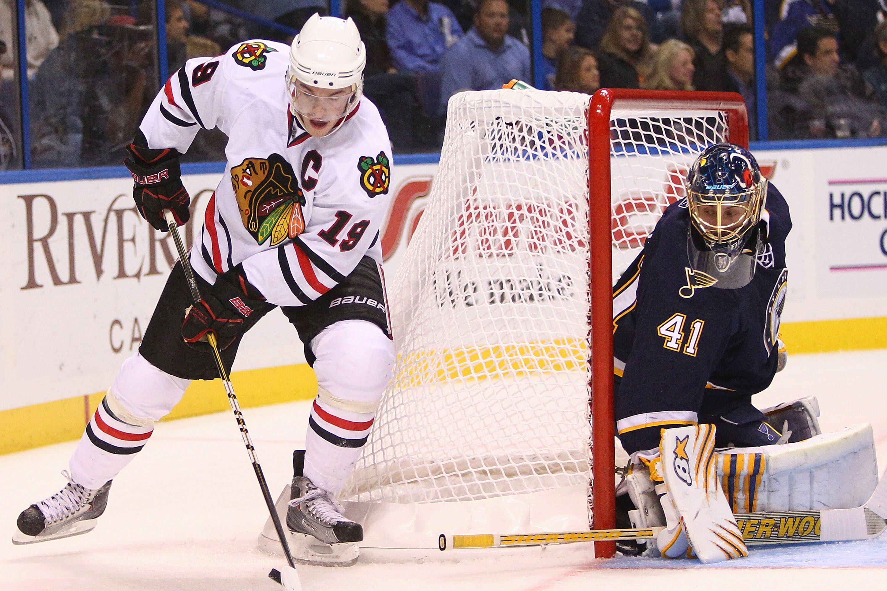 ST. LOUIS - OCTOBER 22: Jonathan Toews #19 of the Chicago Blackhawks looks to get the puck past Jaroslav Halak #41 of the St. Louis Blues at the Scottrade Center on October 22, 2010 in St. Louis, Missouri.  (Photo by Dilip Vishwanat/Getty Images)