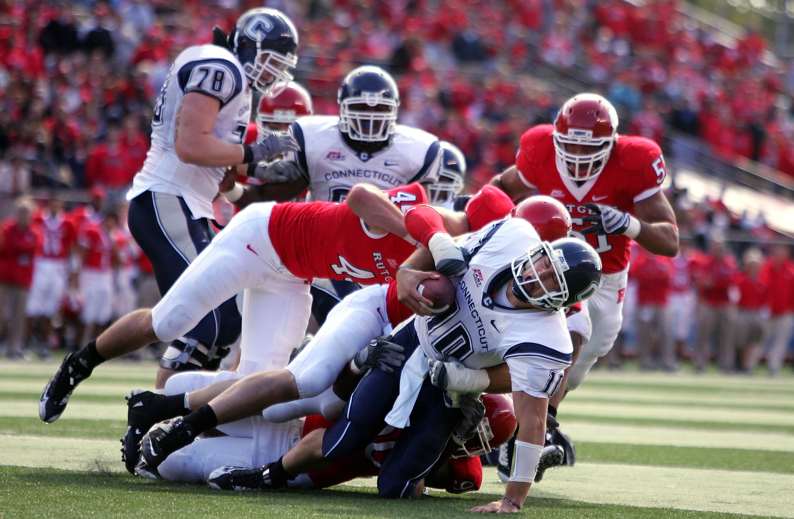 PISCATAWAY, NJ - OCTOBER 18:  Quarterback Zach Frazer #10 of the Connecticut Huskies is stopped just short of the goalline by the defense of the Rutgers Scarlet Knights at Rutgers Stadium on October 18, 2008 in Piscataway, New Jersey.  (Photo by Jim McIsa
