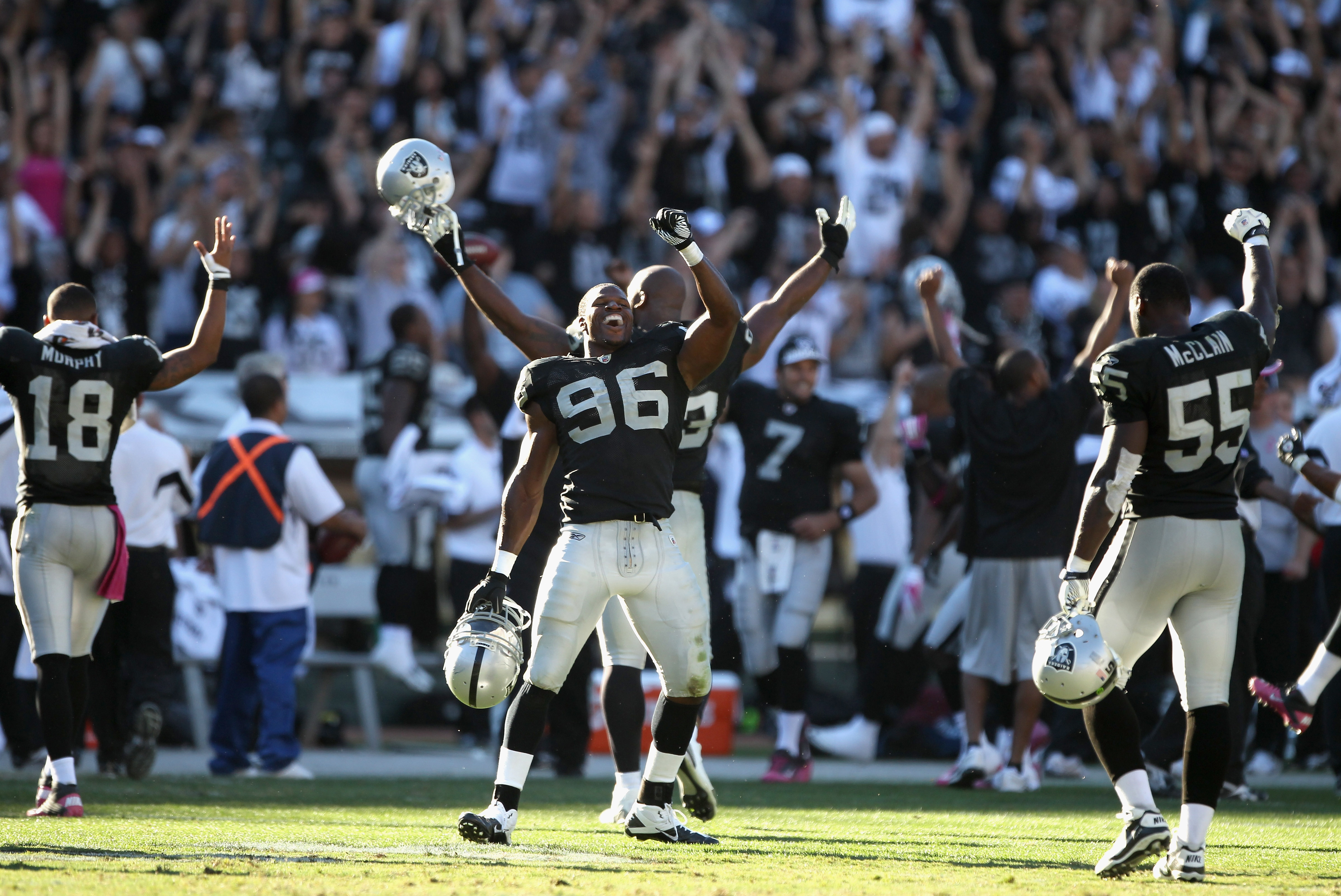 OAKLAND, CA - OCTOBER 10:  Kamerion Wimbley #96 and the rest of the Oakland Raiders celebrate after a replay review ruled that the Tyvon Branch fumble return was a touchdown in the fourth quarter of their game against the San Diego Chargers at Oakland-Ala