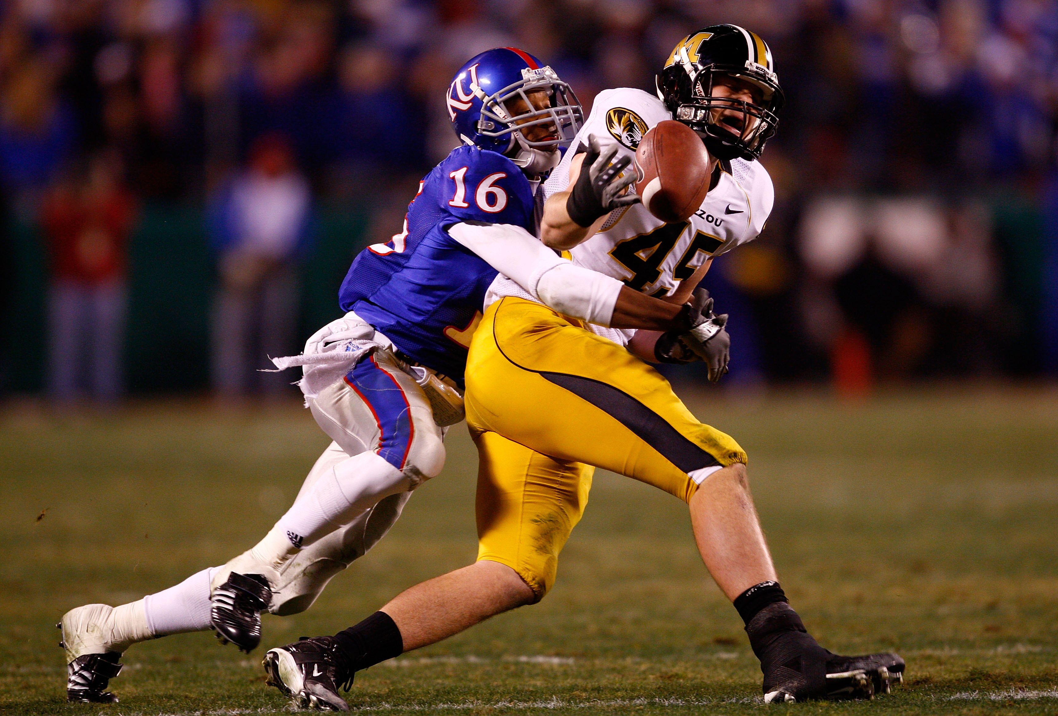 KANSAS CITY, MO - NOVEMBER 24:  Chris Harris #16 of the Kansas Jayhawks breaks up a pass intended for Chase Coffman #45 of the Missouri Tigers during the game at Arrowhead Stadium November 24, 2007 in Kansas City, Missouri.  (Photo by Jamie Squire/Getty I