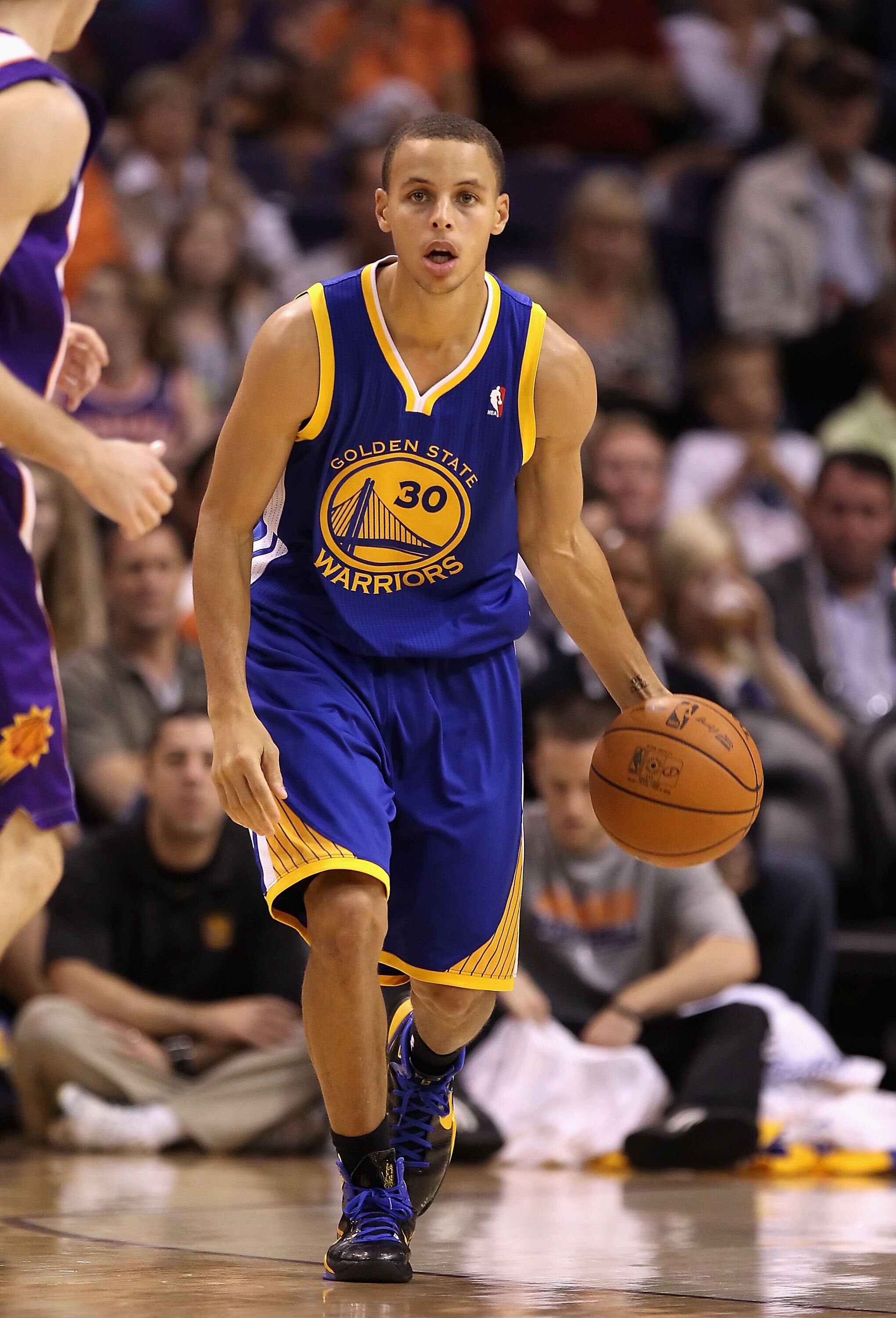 PHOENIX - OCTOBER 19:  Stephen Curry #30 of the Golden State Warriors handles the ball during the preseason NBA game against the Phoenix Suns at US Airways Center on October 19, 2010 in Phoenix, Arizona. NOTE TO USER: User expressly acknowledges and agree
