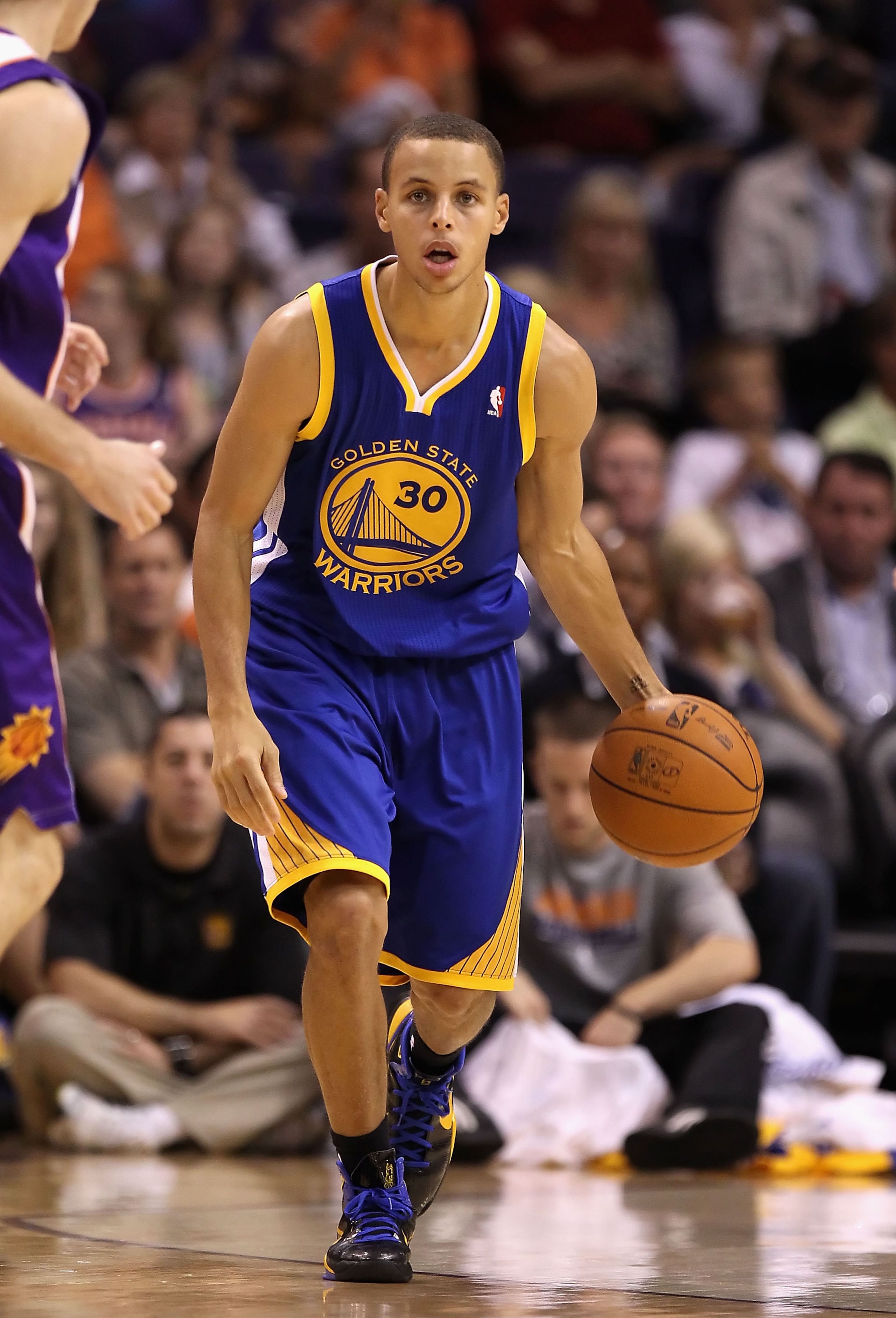 PHOENIX - OCTOBER 19:  Stephen Curry #30 of the Golden State Warriors handles the ball during the preseason NBA game against the Phoenix Suns at US Airways Center on October 19, 2010 in Phoenix, Arizona. NOTE TO USER: User expressly acknowledges and agree