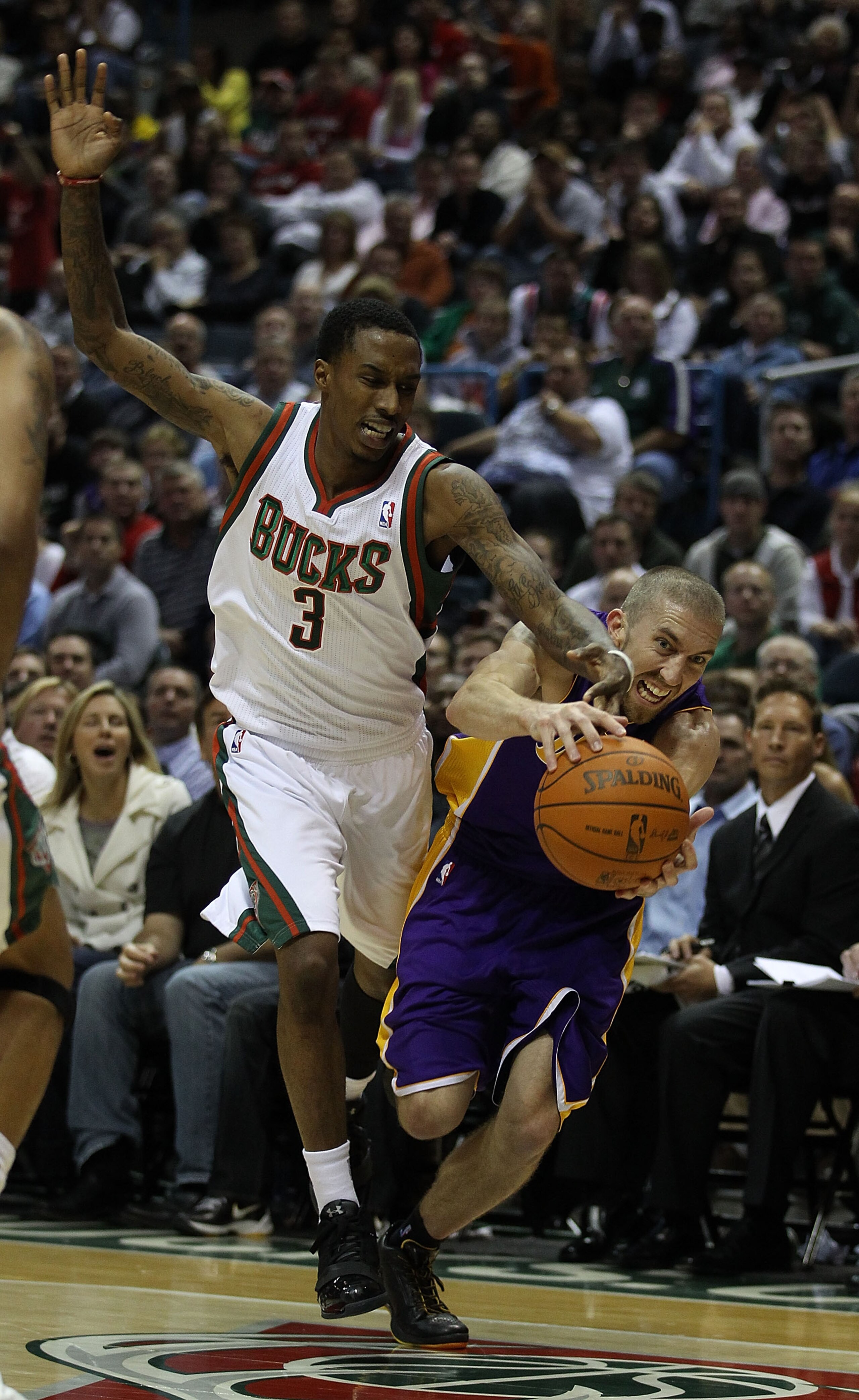 MILWAUKEE - NOVEMBER 16: Brandon Jennings #3 of the Milwaukee Bucks and Steve Blake #5 of the Los Angeles Lakers battle for a loose ball at the Bradley Center on November 16, 2010 in Milwaukee, Wisconsin. The Lakers defeated the Bucks 118-107. NOTE TO USE