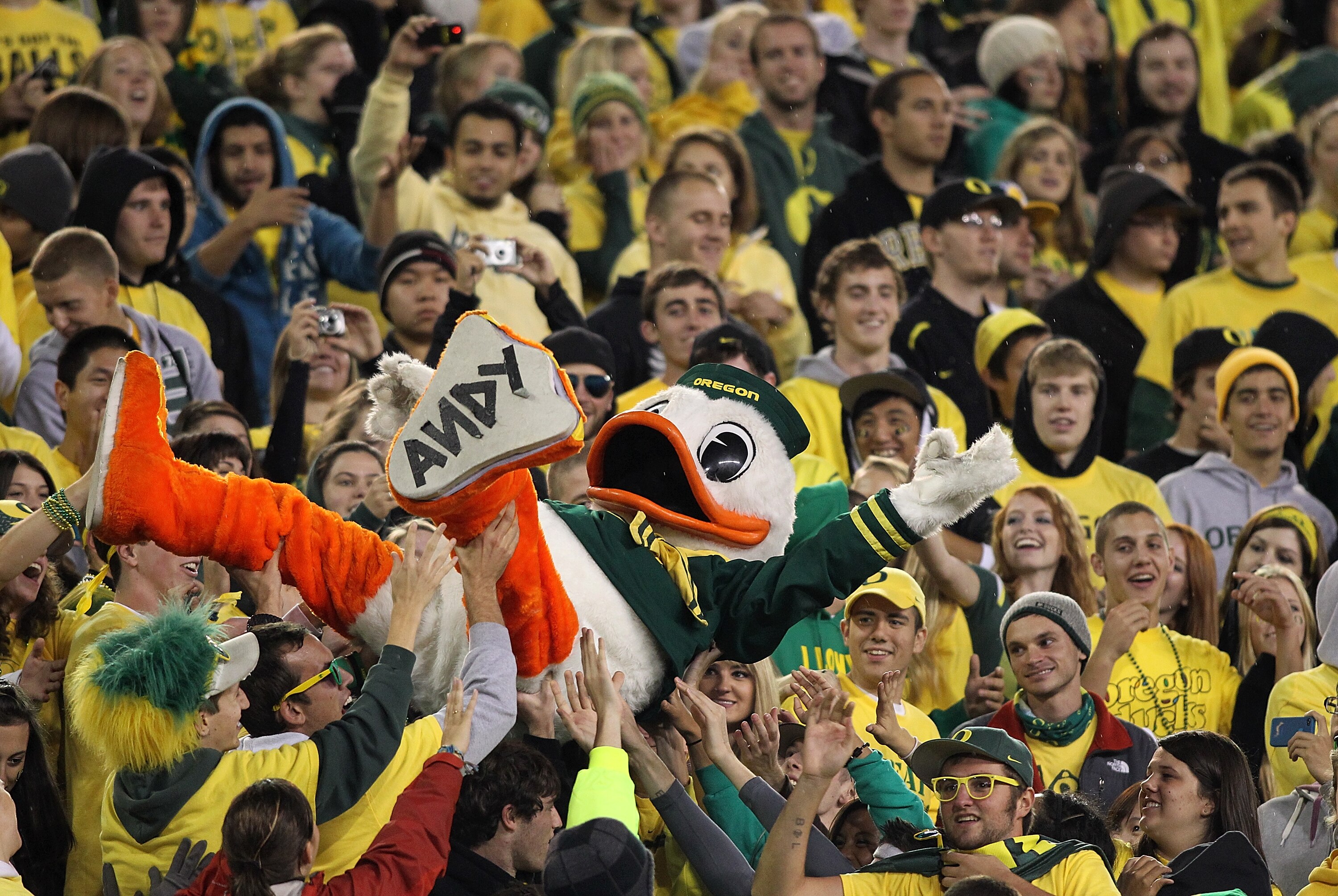 EUGENE, OR - OCTOBER 21:  The Oregon Duck mascot is lifted into the crowd during the game against the UCLA Bruins  on October 21, 2010 at the Autzen Stadium in Eugene, Oregon.  (Photo by Jonathan Ferrey/Getty Images)