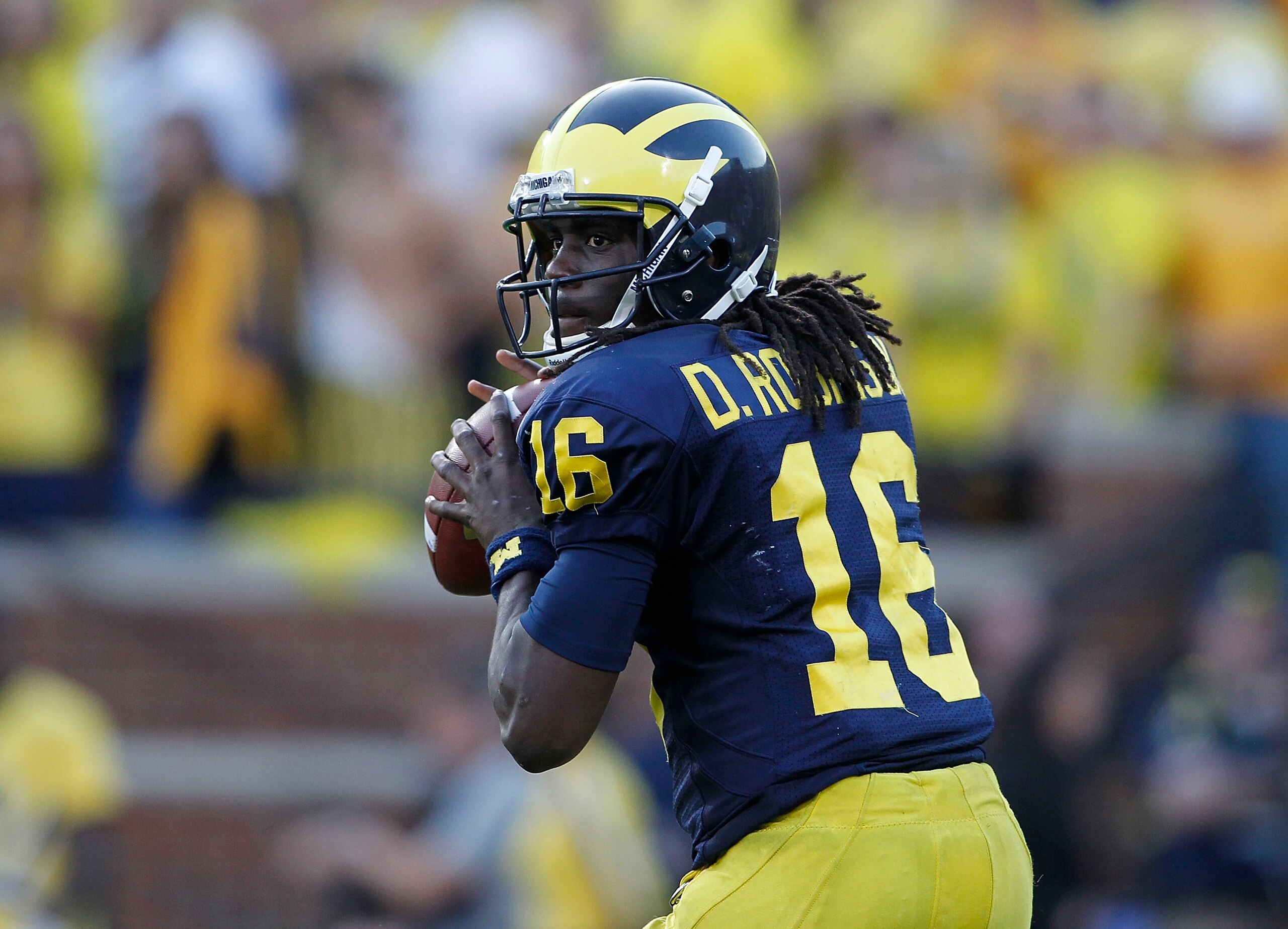 ANN ARBOR, MI - OCTOBER 09:  Denard Robinson #16 of the Michigan Wolverines drops back to pass during the game against the Michigan State Spartans on October 9, 2010 at Michigan Stadium in Ann Arbor, Michigan. The Michigan State Spartans defeated the Mich