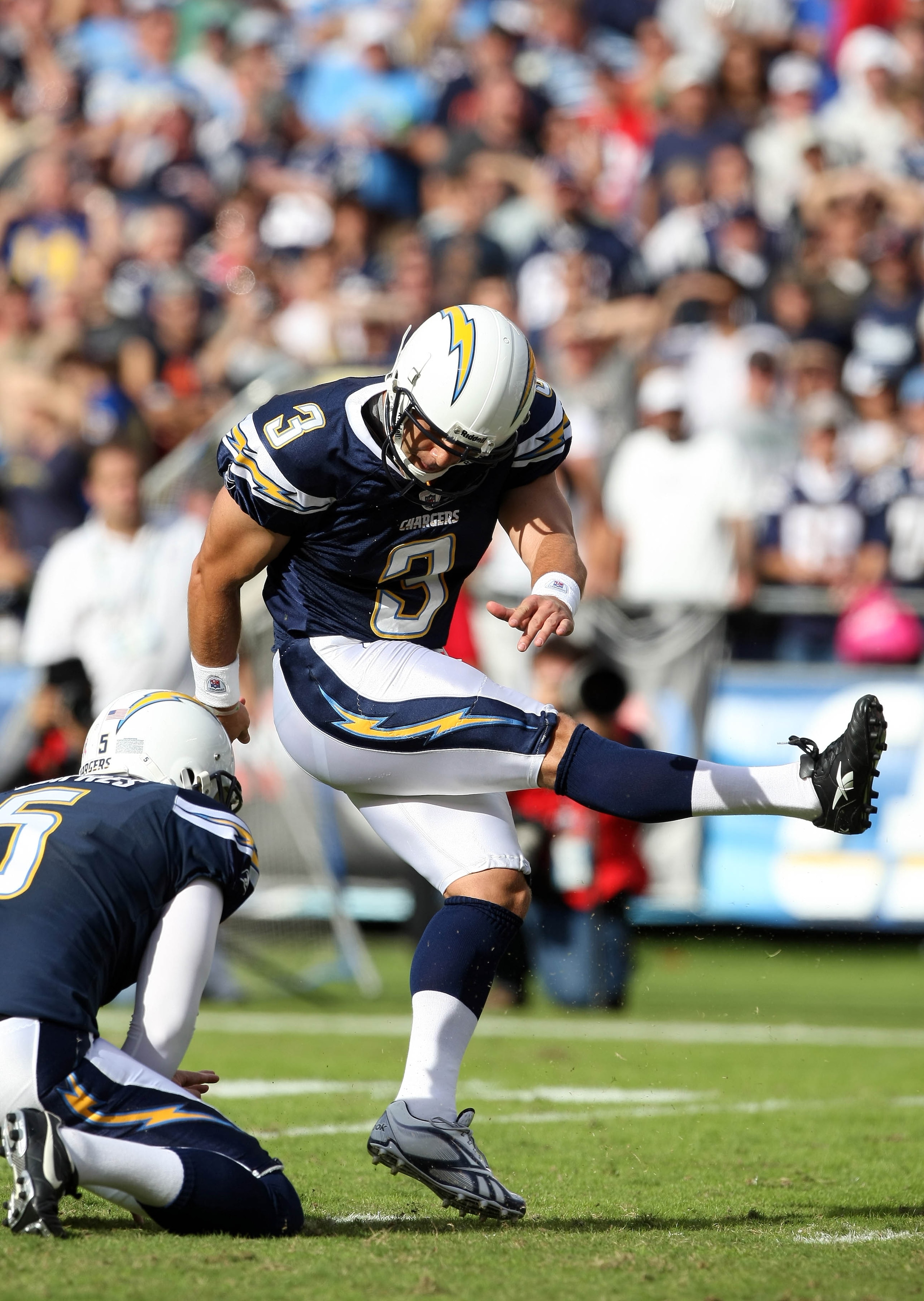 SAN DIEGO - OCTOBER 24:  Kicker Kris Brown #3 kicks a filed goal as teammate Mike Scifres #5 holds against the New England Patriots during NFL game on October 24, 2010 at Qualcomm Stadium in San Diego, California. (Photo by Donald Miralle/Getty Images)