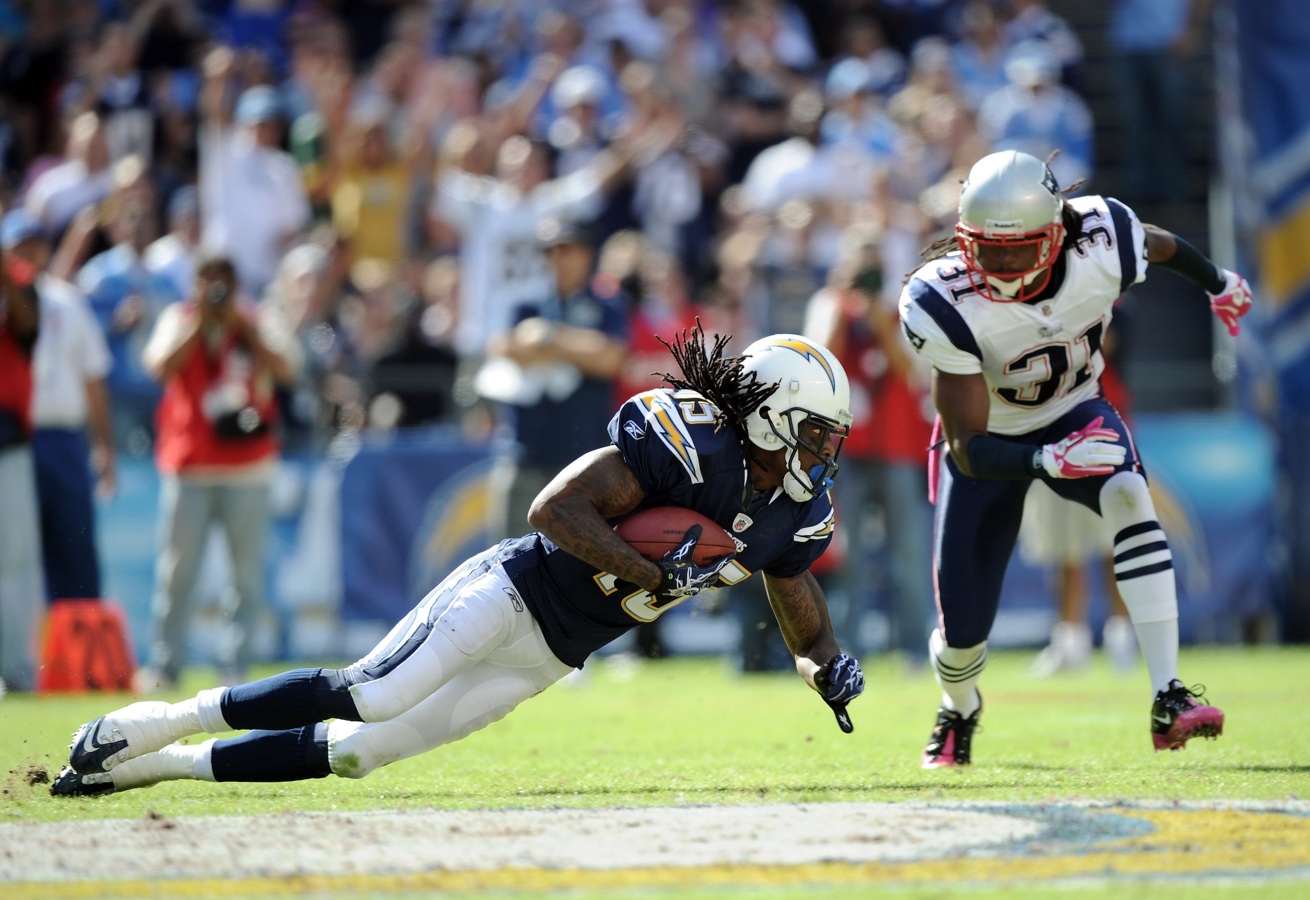 SAN DIEGO - OCTOBER 24:  Richard Goodman #15 of the San Diego Chargers makes a catch in front of Brandon Meriweather #31 of the New England Patriots during the second quarter at Qualcomm Stadium on October 24, 2010 in San Diego, California. Goodman fumble